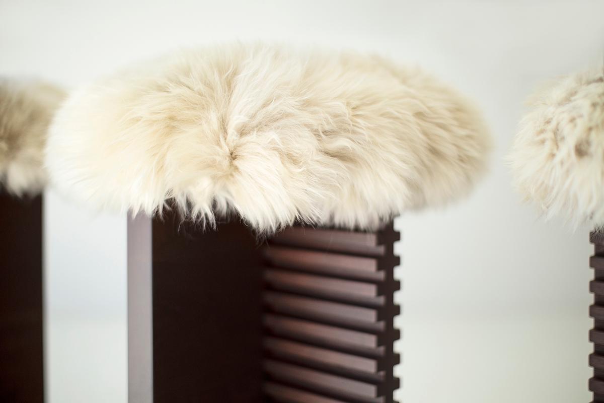 This Modern Cicely Counter Stool with Sheepskin Seat is beautifully constructed from solid walnut in Ohio, USA. This stool was style-spotted at the Spring 2022 High Point Market. These stools are modern and architectural with a comfortable long