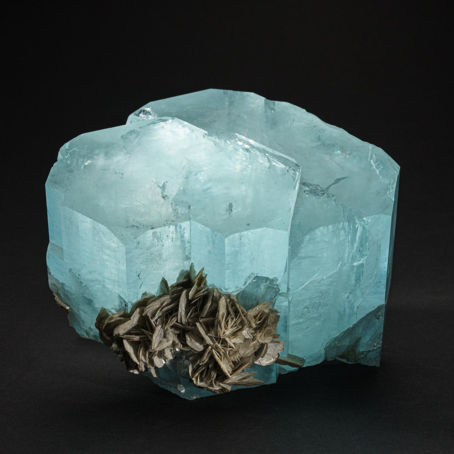 From Dusso, Gilgit District, Gilgit-Baltistan, Pakistan

Lustrous translucent to transparent beryl var. aquamarine crystals in a parallel growth formation. The smaller crystal along the side appears to have faces showing subparallel growth.

