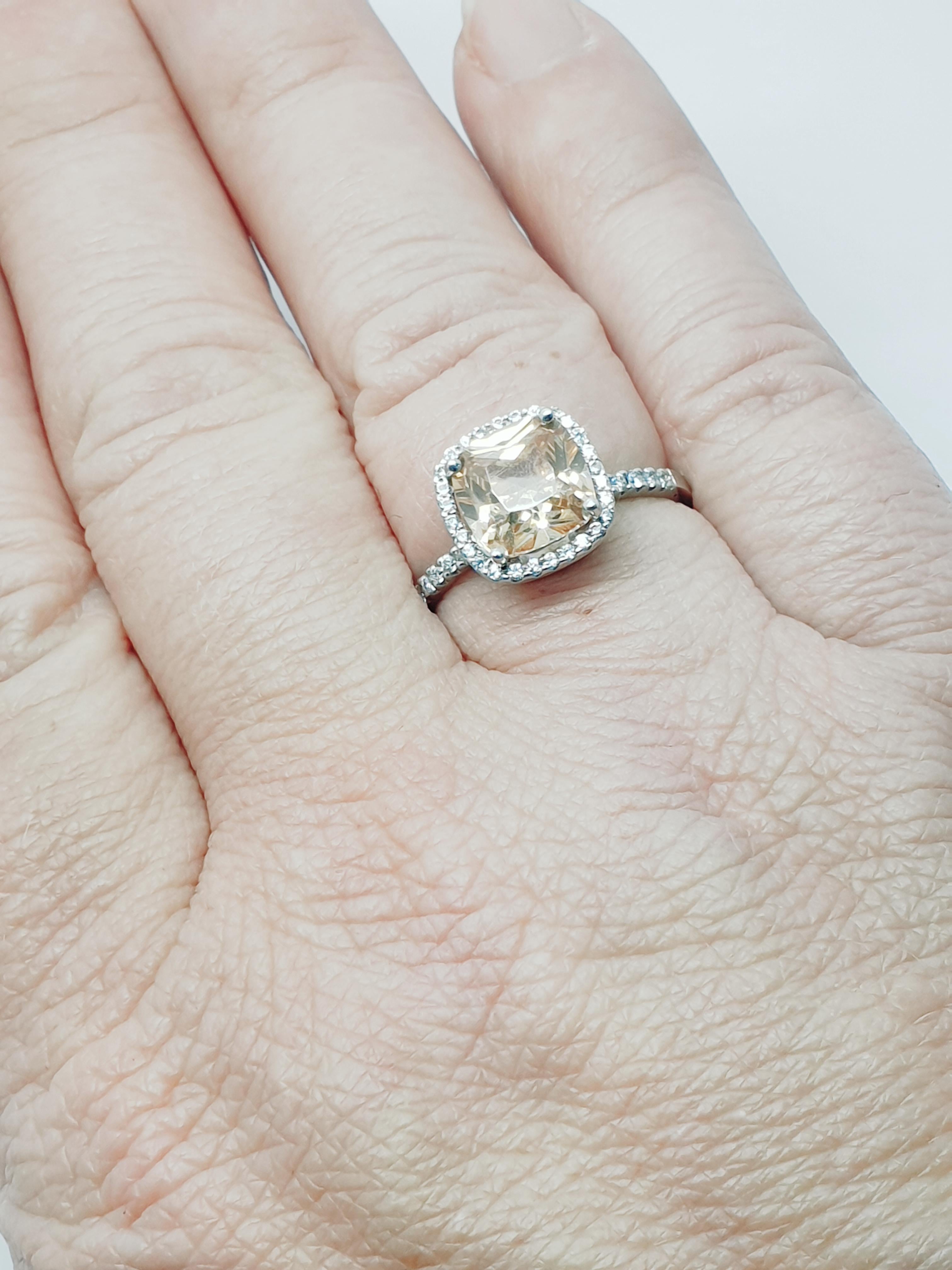 Offering for sale a bespoke made halo style zircon diamond ring. The zircon has a lovely peachy color cushion shape about 2.5 carat weight.The center stone surrounded with small diamonds . The diamonds total weight 0.16 ct.The ring is 18 karat white