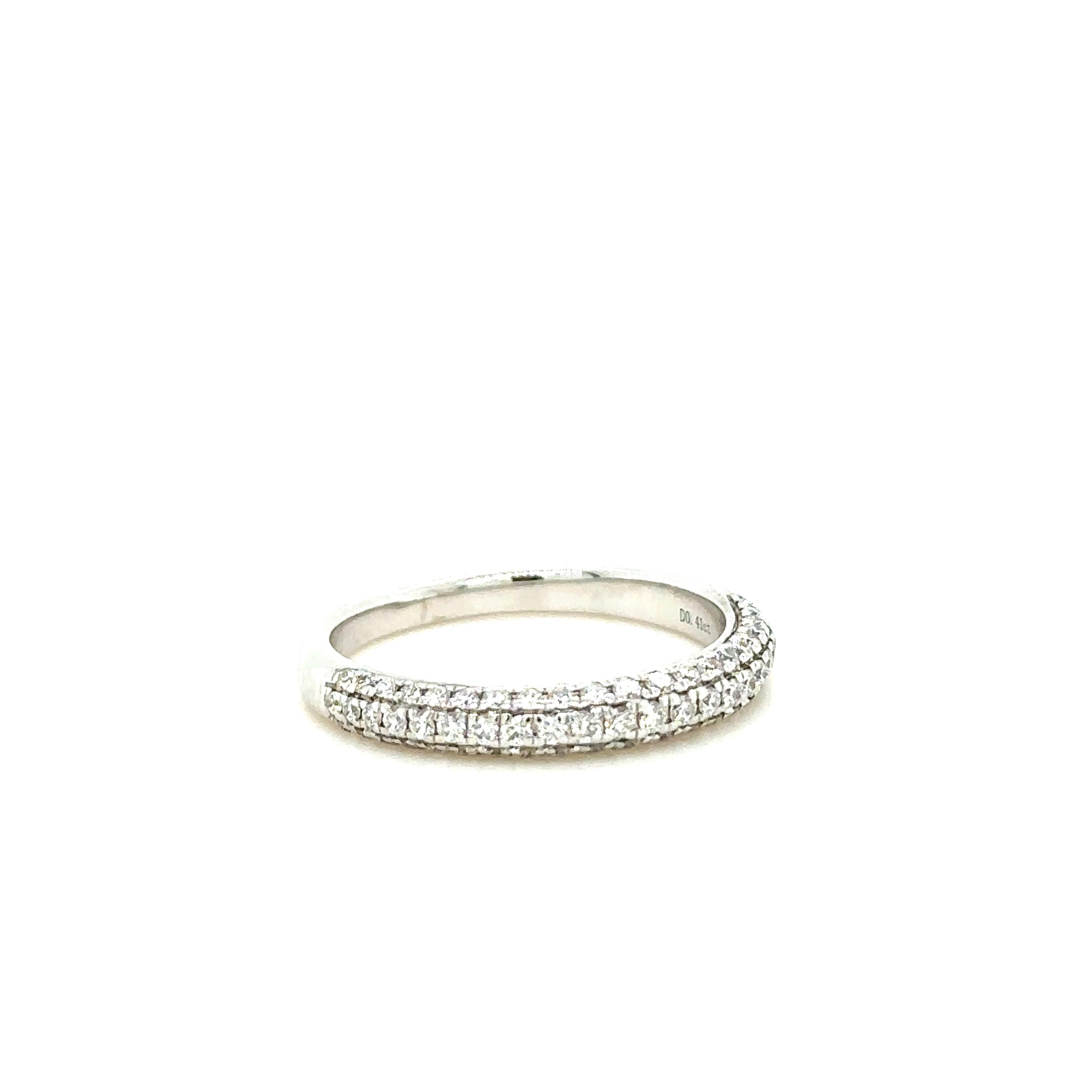 Unique features:

Diamond half eternity band. Made of 18 kt White Gold, in a pave setting, and weighing 2.9gm. Stamped: 18K 750.

Set with 67 round, brilliant cut Diamonds, colour F-G and clarity VS-SI. with a total weight of 0.41ct.

Metal: 18ct