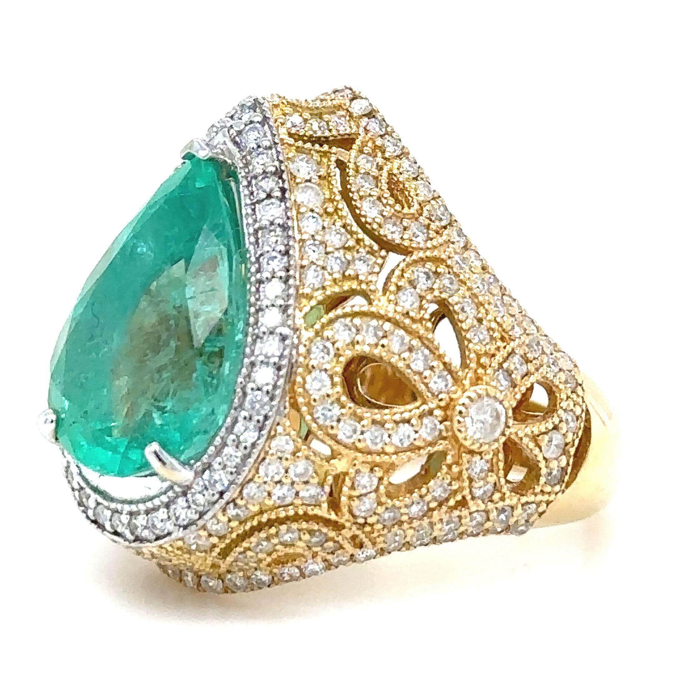 A Emerald & Diamond Dress ring, made of 18ct White & Yellow Gold. Set with a Pear, Mixed Cut Zambian Green Emerald weighing 5.35ct.

Additionally set with 247 Round Brilliant Cut Diamonds, G-J Colour, SI-I2 Clarity, weighing 1.33ct. Total carat