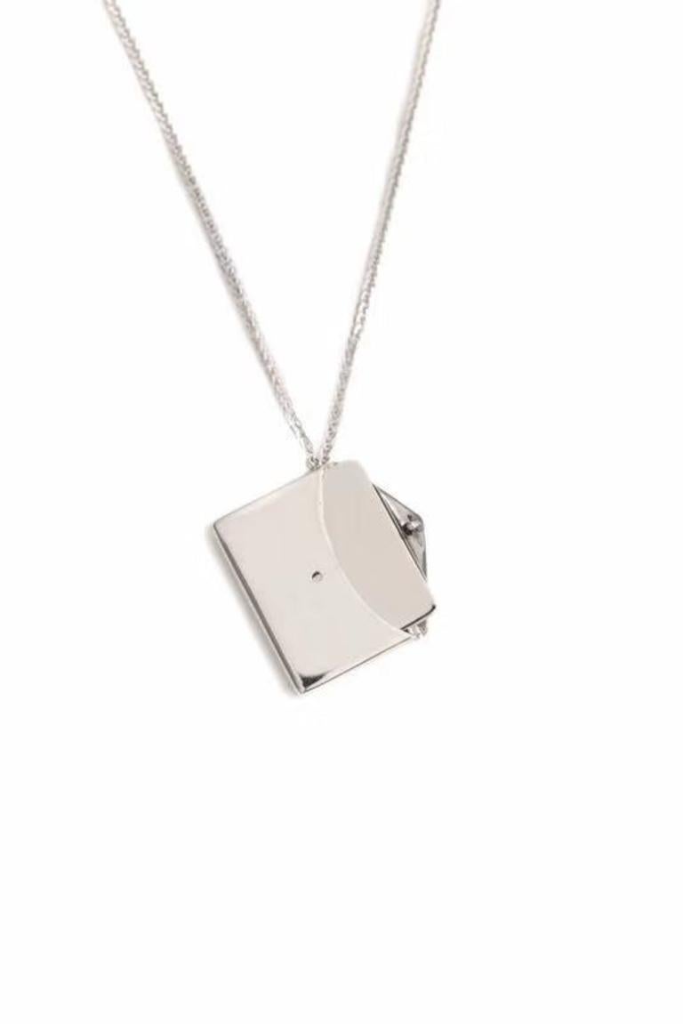 This enchanting pendant necklace has been crafted to the finest detail. A single envelope hangs on a rich gold chain, with a single diamond luring you in for closer inspection. From here you are able to open the envelope and retrieve a letter which