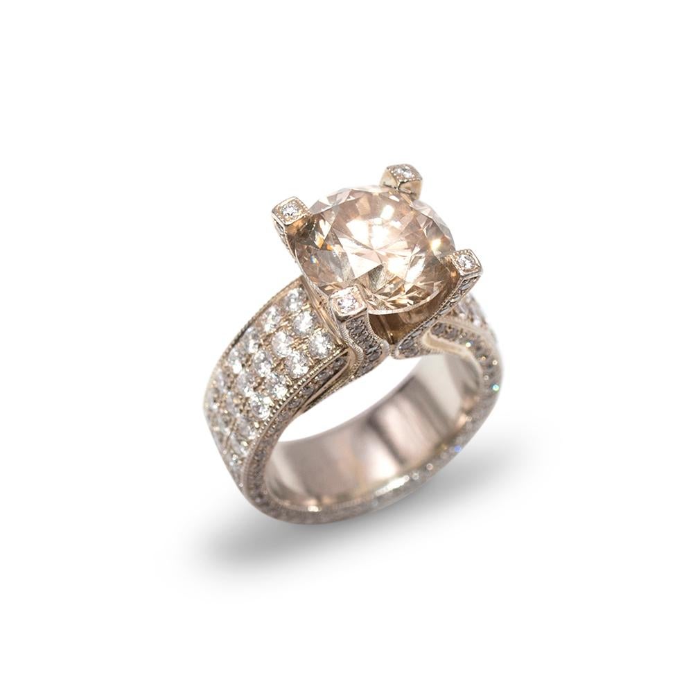 Bespoke 19ct Gold 5.5ct Fancy Champagne Diamond Ring

- SI2 Clarity 

- 1 x 11mm fancy champagne round cut diamond solitaire in a 4 prong setting

- 90 x 2mm round pave set diamonds to the band with 72 x 1mm round pave diamonds to the inside of the