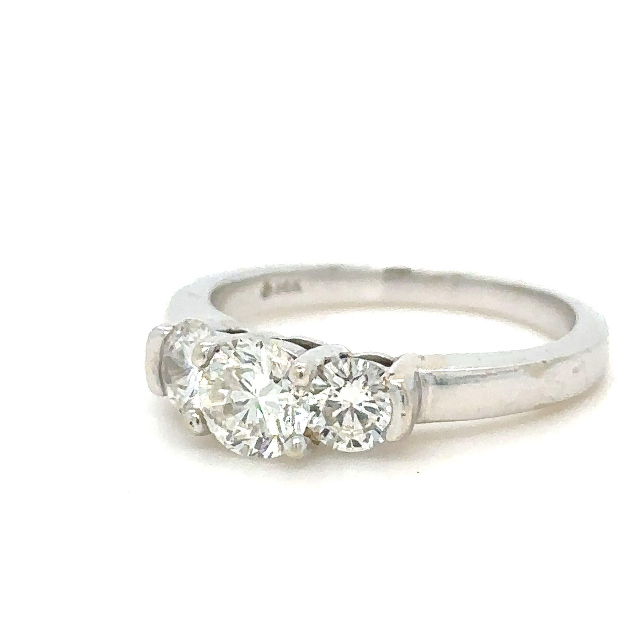 A Bespoke 3 Diamond Round Brilliant Cut Ring, claw set in 14ct white gold with a round brilliant cut diamond on each shoulder on a 2.2mm band.

Diamonds 1 = 0.53 ct (estimated), Graded in setting as Colour: H, Clarity: VS2

2 = 0.54ct (estimated),