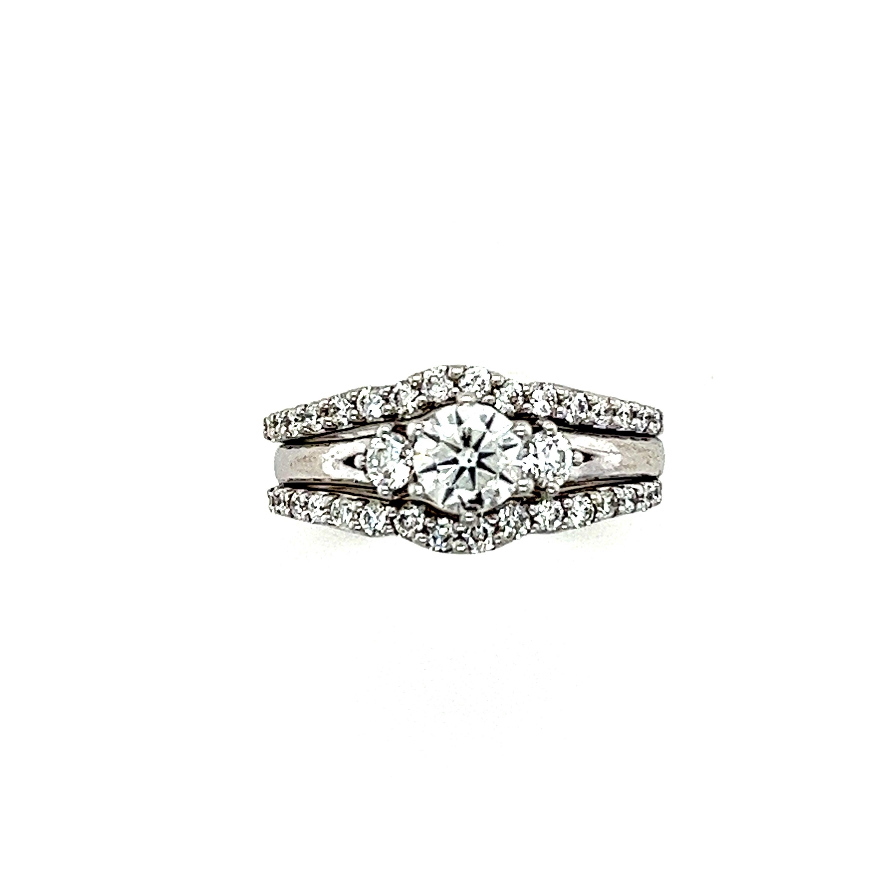 A Three-Piece Diamond Bridal Ring Joined Set with the centre engagement ring with 3 round brilliant cut diamonds within a border of 32 round brilliant cut diamonds all set in 18ct white gold.

Diamonds 1 = 0.46ct (estimated), graded in setting as