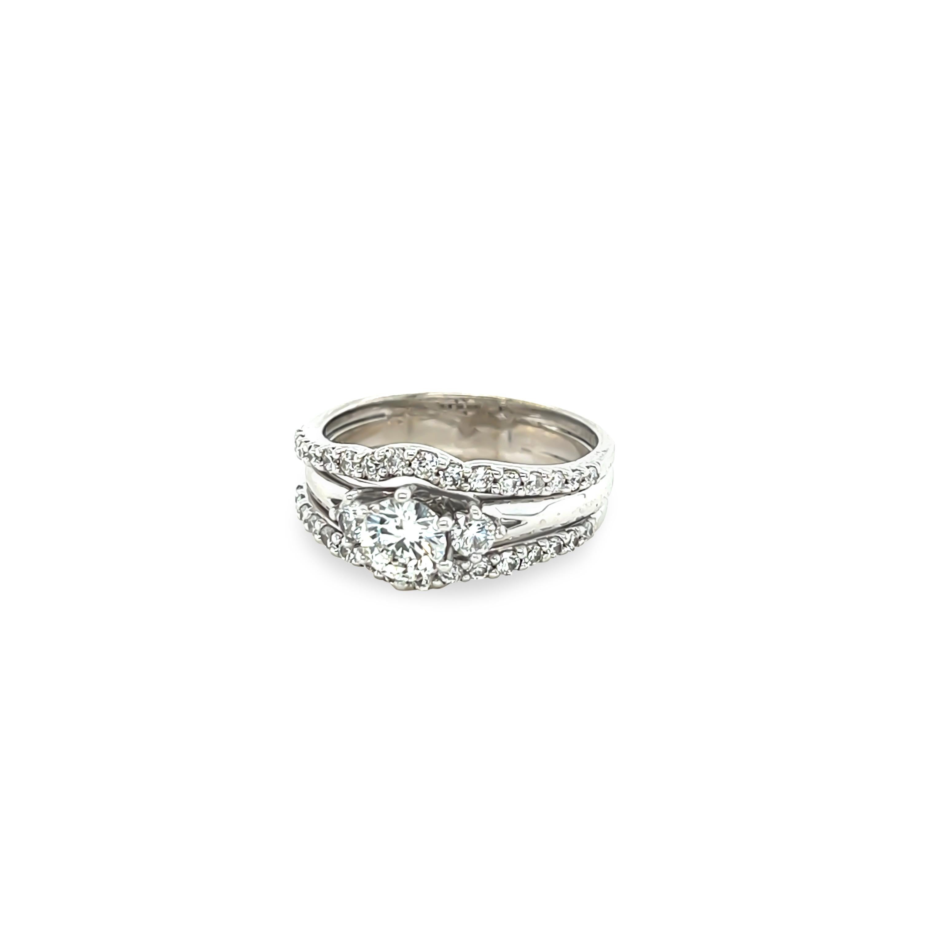 A Three-Piece Diamond Bridal Ring Joined Set with the centre engagement ring with 3 round brilliant cut diamonds within a border of 32 round brilliant cut diamonds all set in 18ct white gold.

Diamonds 1 = 0.46ct (estimated), graded in setting as