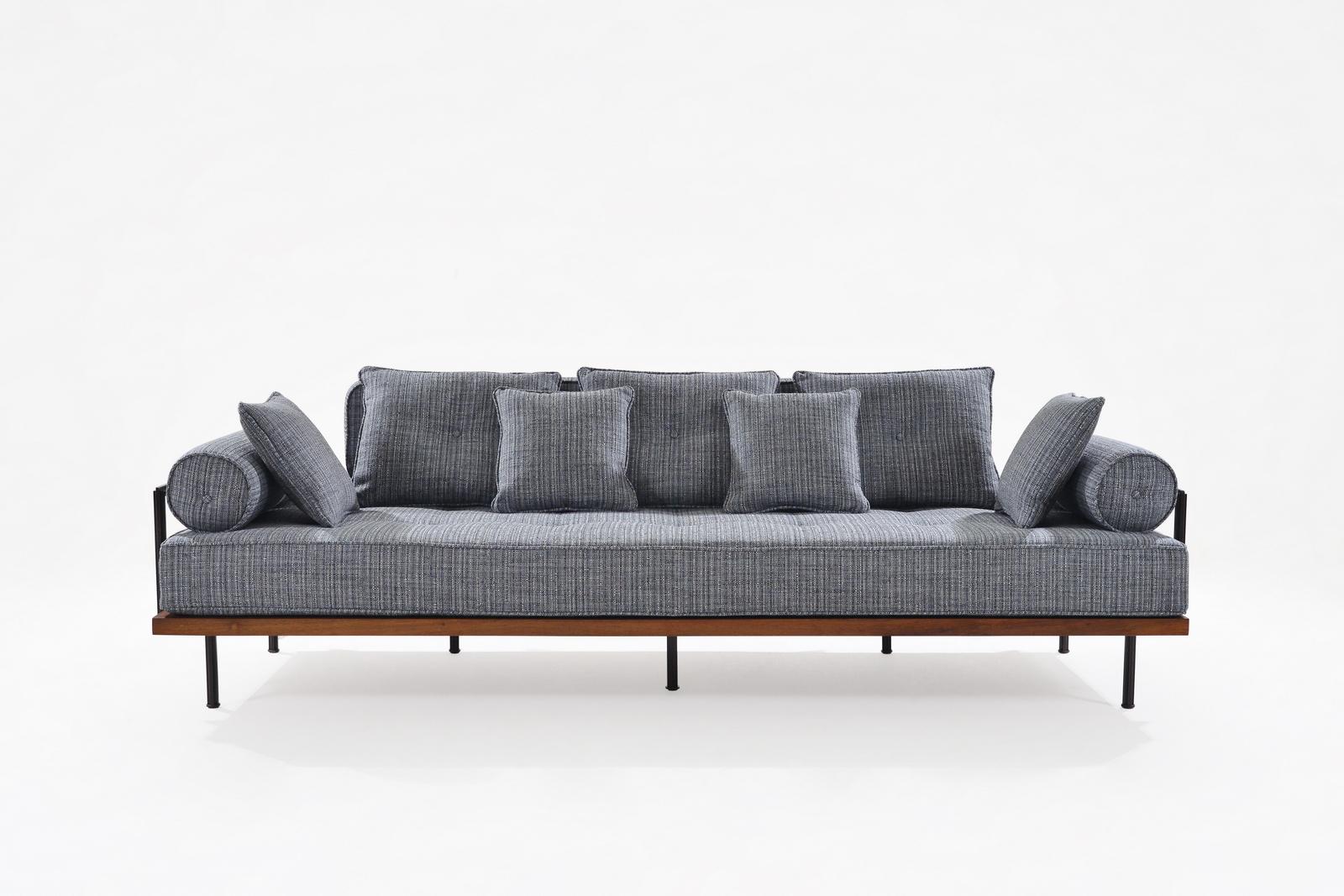 Introducing our contemporary three-seater sofa, a testament to 21st-century vintage elegance. Meticulously crafted with the precision synonymous with P. Tendercool, this sofa is constructed from reclaimed wood, solid brass, and indulgent
