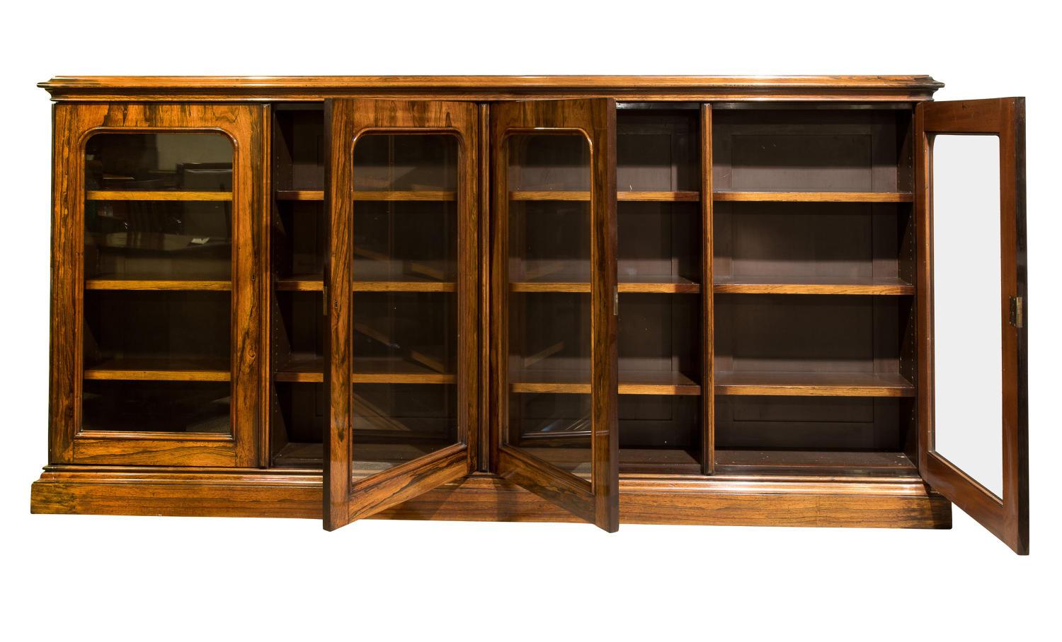 A rare, bespoke four door glazed bookcase, made from rosewood with mahogany ends. This stunning piece of furniture has unique features in the form of its shelf supports,
circa 1880.