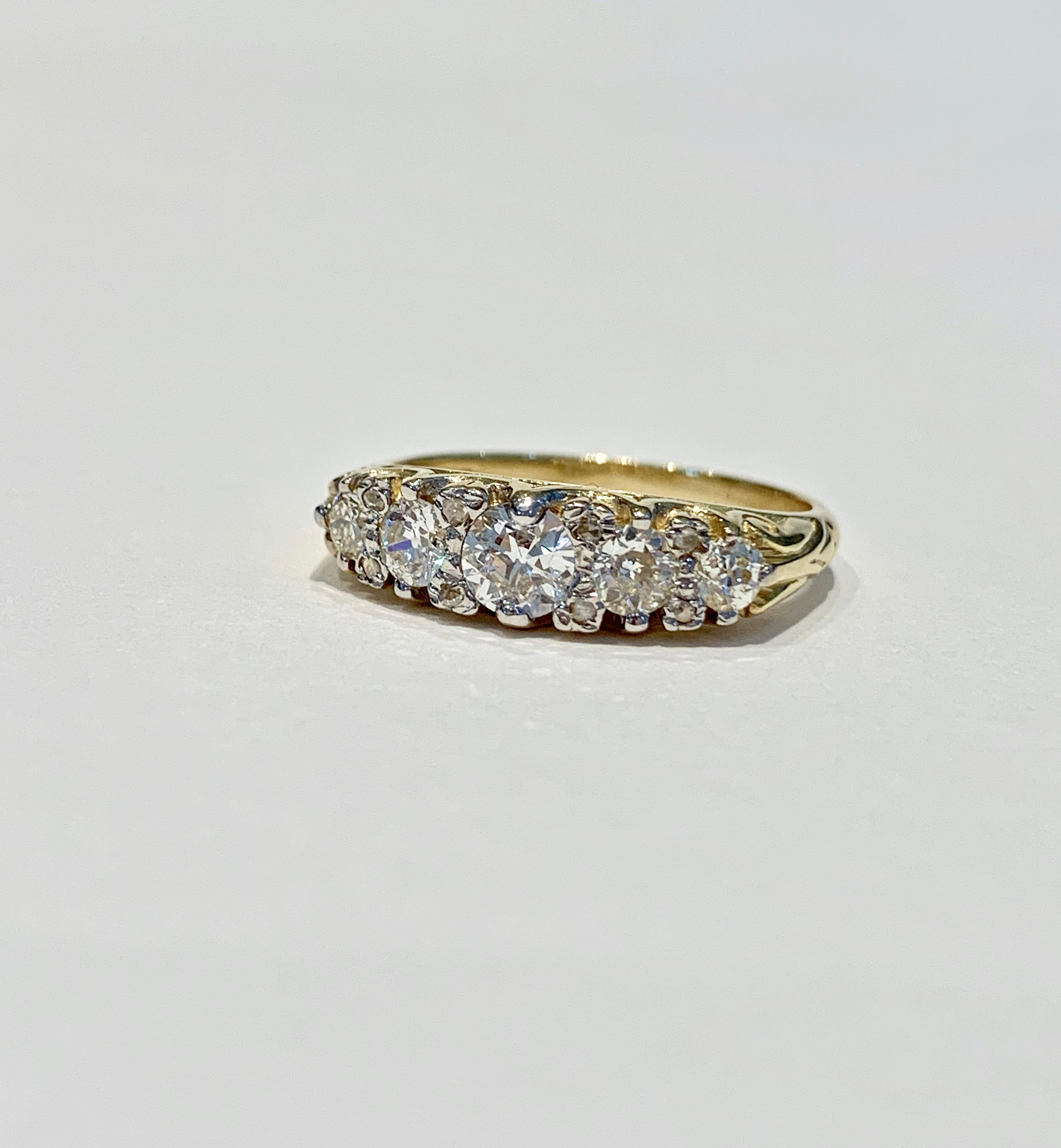 This Bespoke 5 stone ring is set with graduating round Old Cut* diamonds, approximately 1.30 ct. in total.   The scintillation and rainbow colours coming from all the diamonds is stunning.  
The ring has recently been handmade with scroll work on