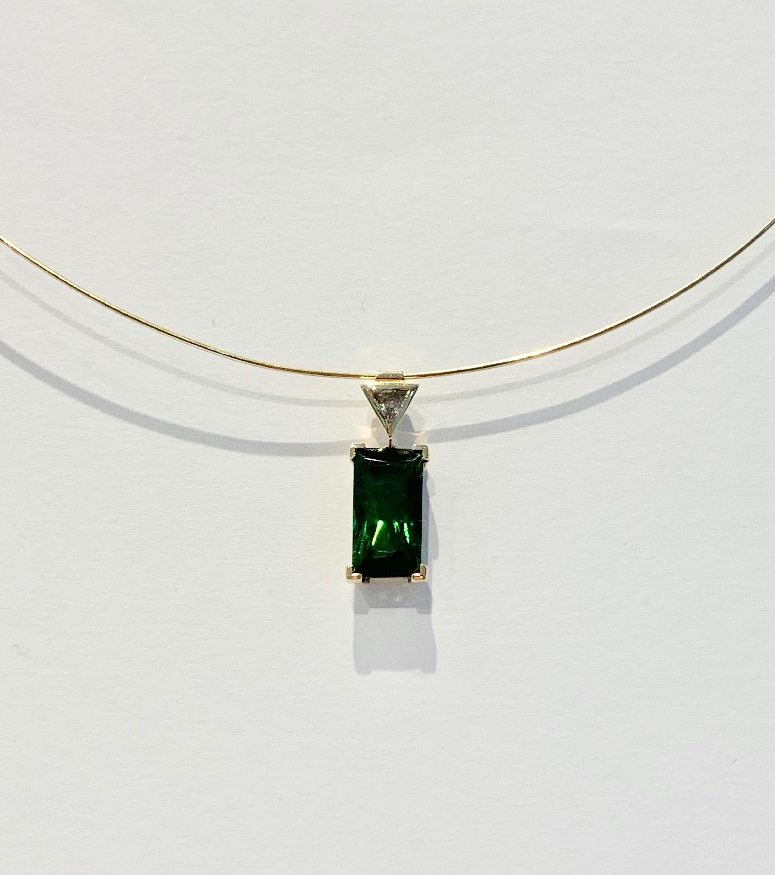 Stunning and eye catching, this gorgeous Bespoke 6.10ct Green Tourmaline* is set in a contemporary design Pendant.  The stone measures 15.6 x 8.7 mm, has a deep bright green colour and amazing clarity.  A CAD was used to make sure the Tourmaline was
