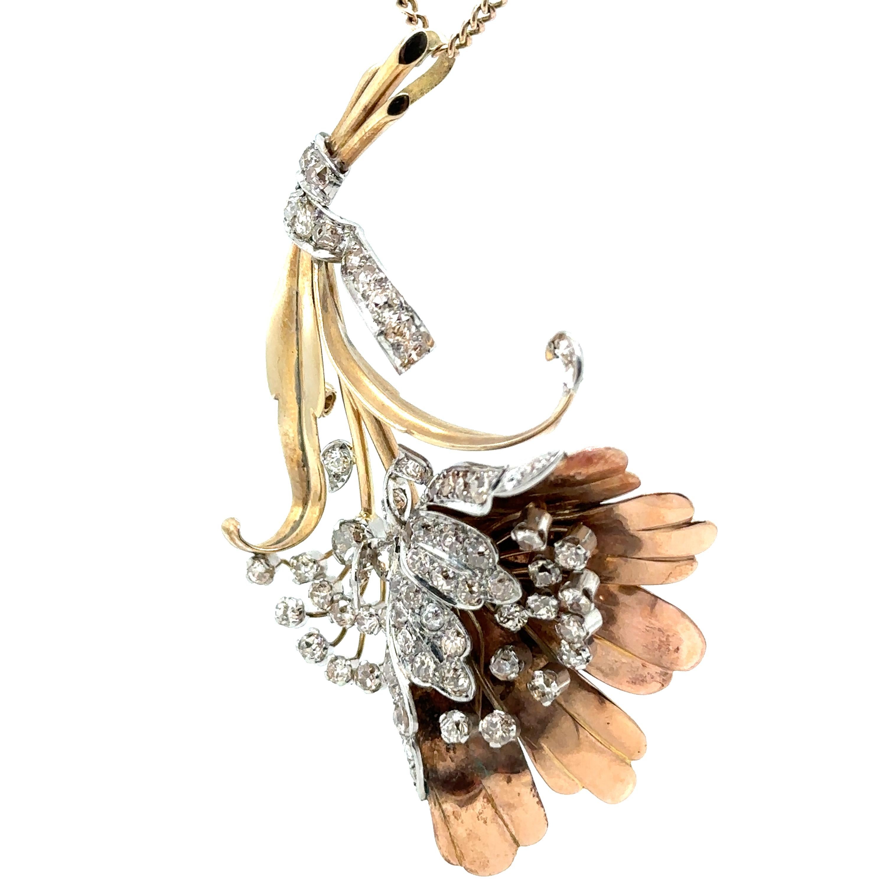 An Antique Diamond Floral Pendant, with 72 Old Cut Diamonds set in Platinum and 9ct Yellow and Rose Gold and suspended on a 14ct Yellow Gold curb link neck chain (Converted from a brooch).

Diamonds 72 = 6.20ct (estimated), Graded in setting as