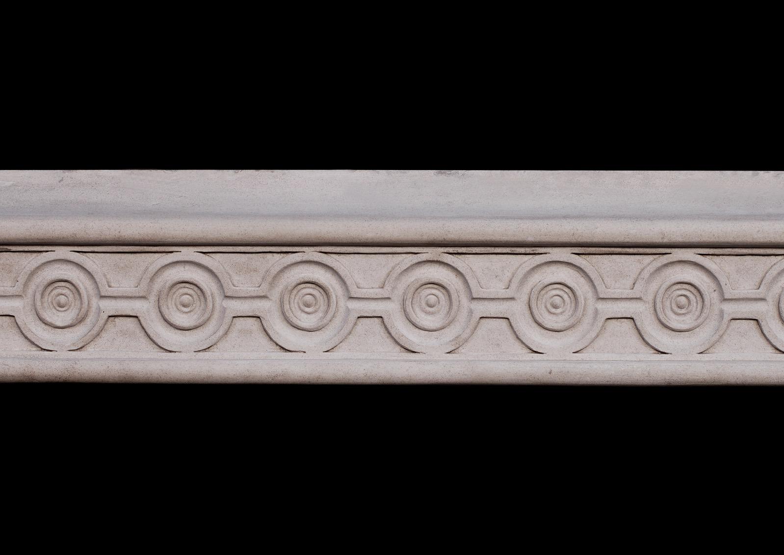An attractive English limestone fireplace. The frieze and jambs with guilloche carving and scotia moulding to outside. With additional shelf. A Fine architectural piece. Modern.

Measures: 
Shelf width: 1435 mm / 56 1/2 in
Overall height: 1175