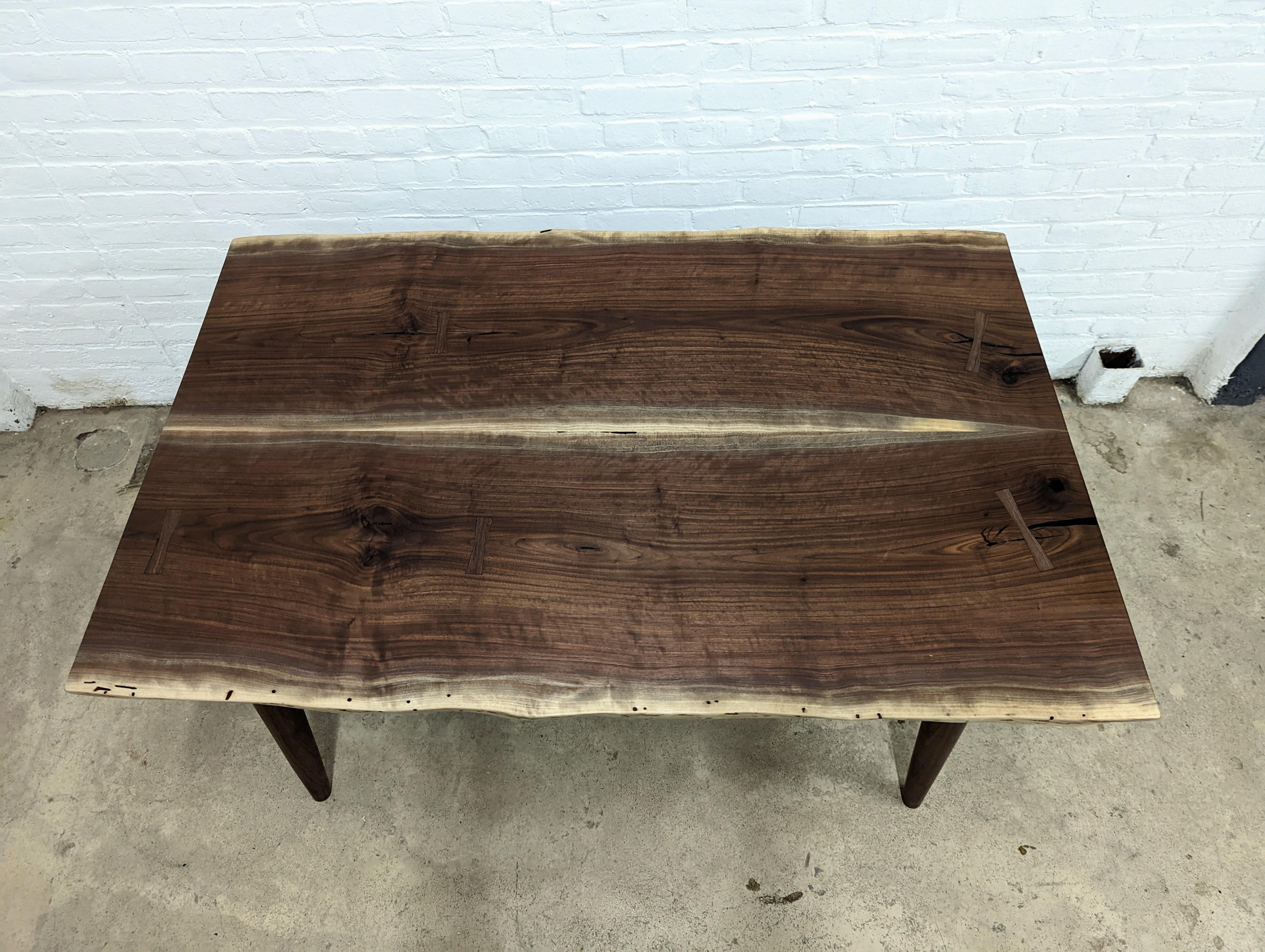 This one of a kind Yarrow dining table is already made, ready for purchase. Crafted by hand from locally salvaged Black Walnut. 

A delightful combination of simplicity and elegance, our dining table will fit beautifully in any dining or hosting