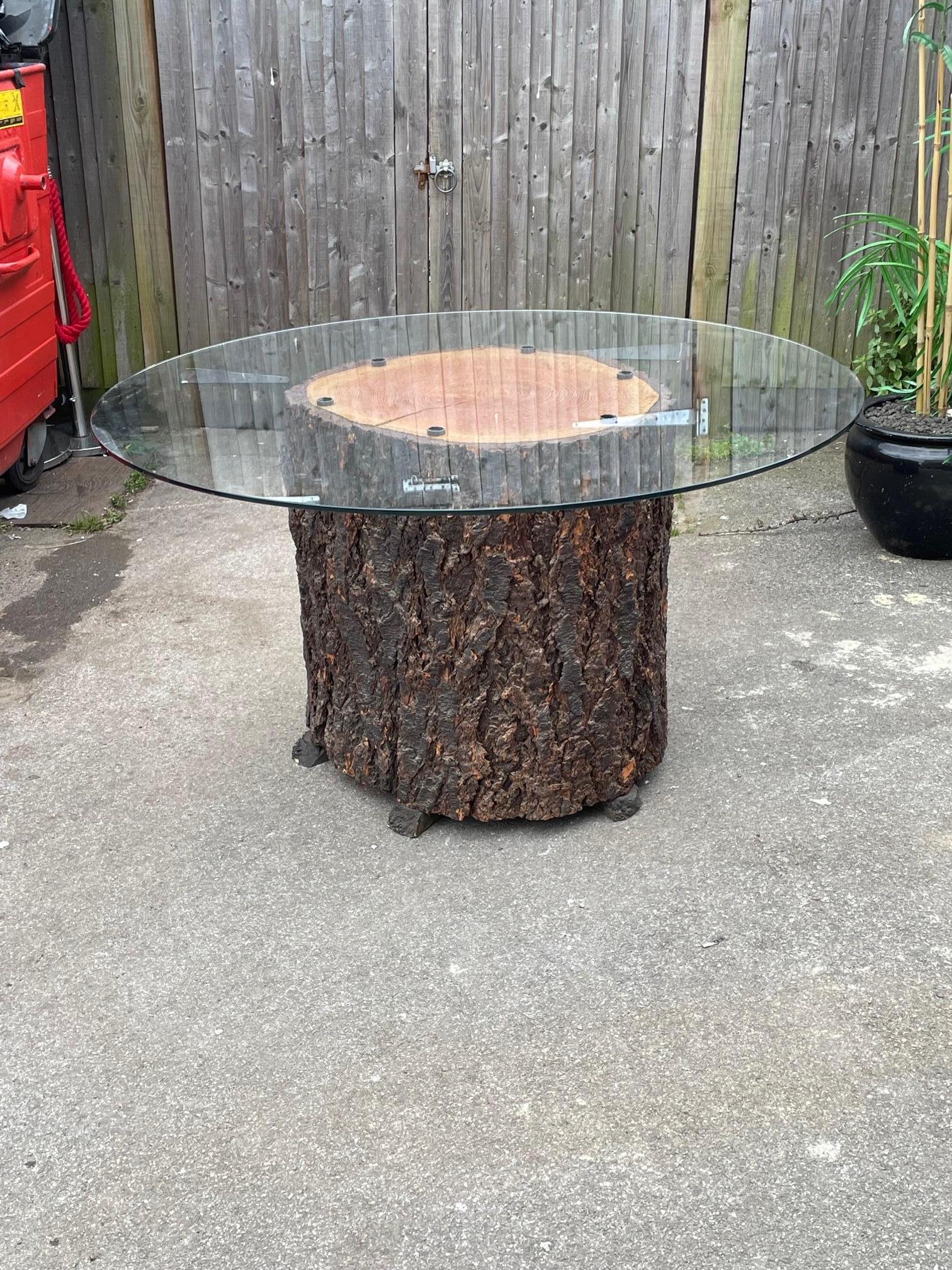 A spectacular center table made using a Douglas Fern trunk, 46 thousand year old bog wood pegs which hold the large glass circular top to the base.

This table has been made by a masters craftsman who made furniture and various items for a lot of