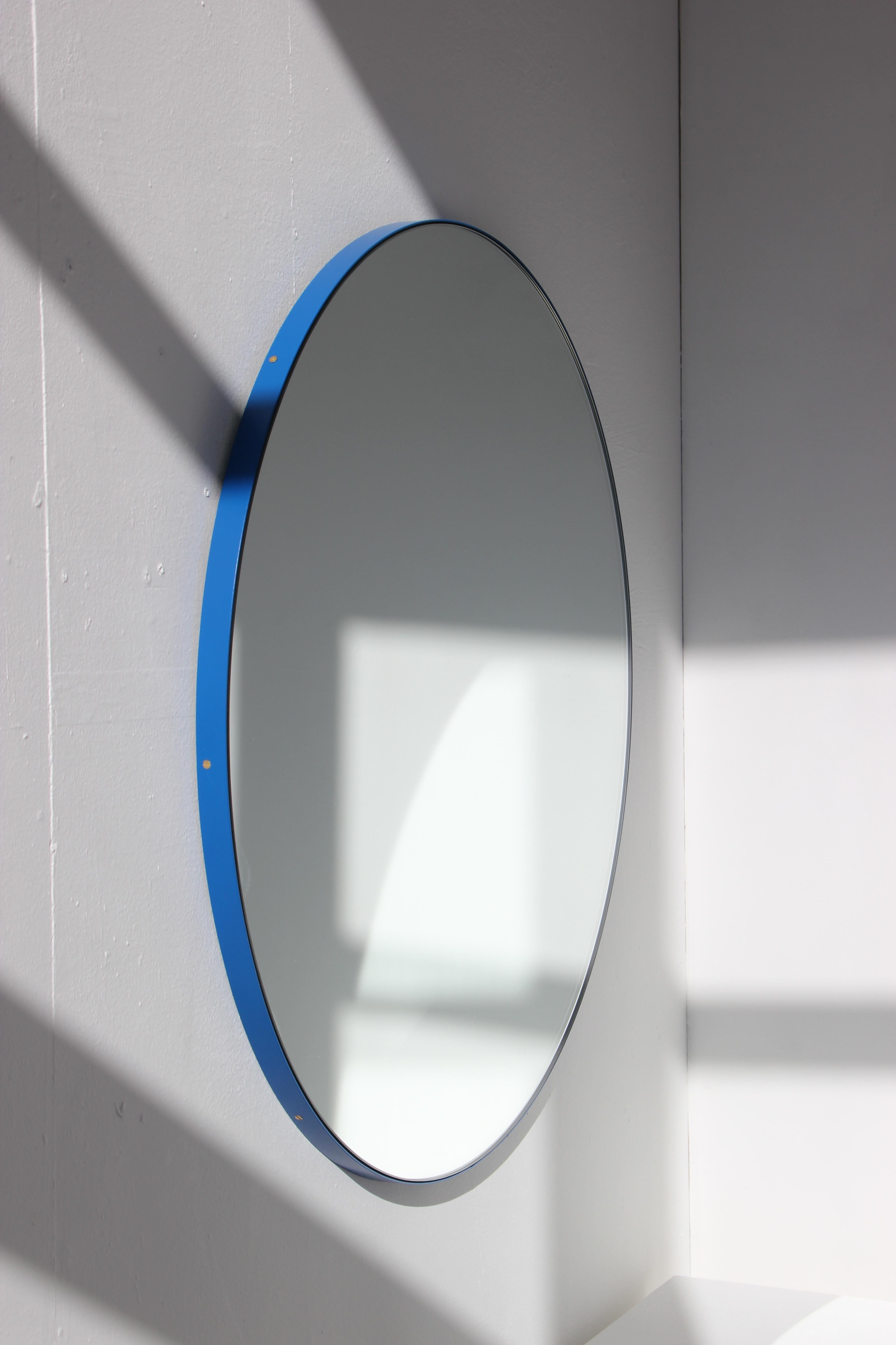 Modern round mirror with a vibrant powder coated aluminium blue frame. Designed and handcrafted in London, UK.

Fitted with a brass hook or an aluminium z-bar depending on the size of the mirror. Also available on demand with a split batten system