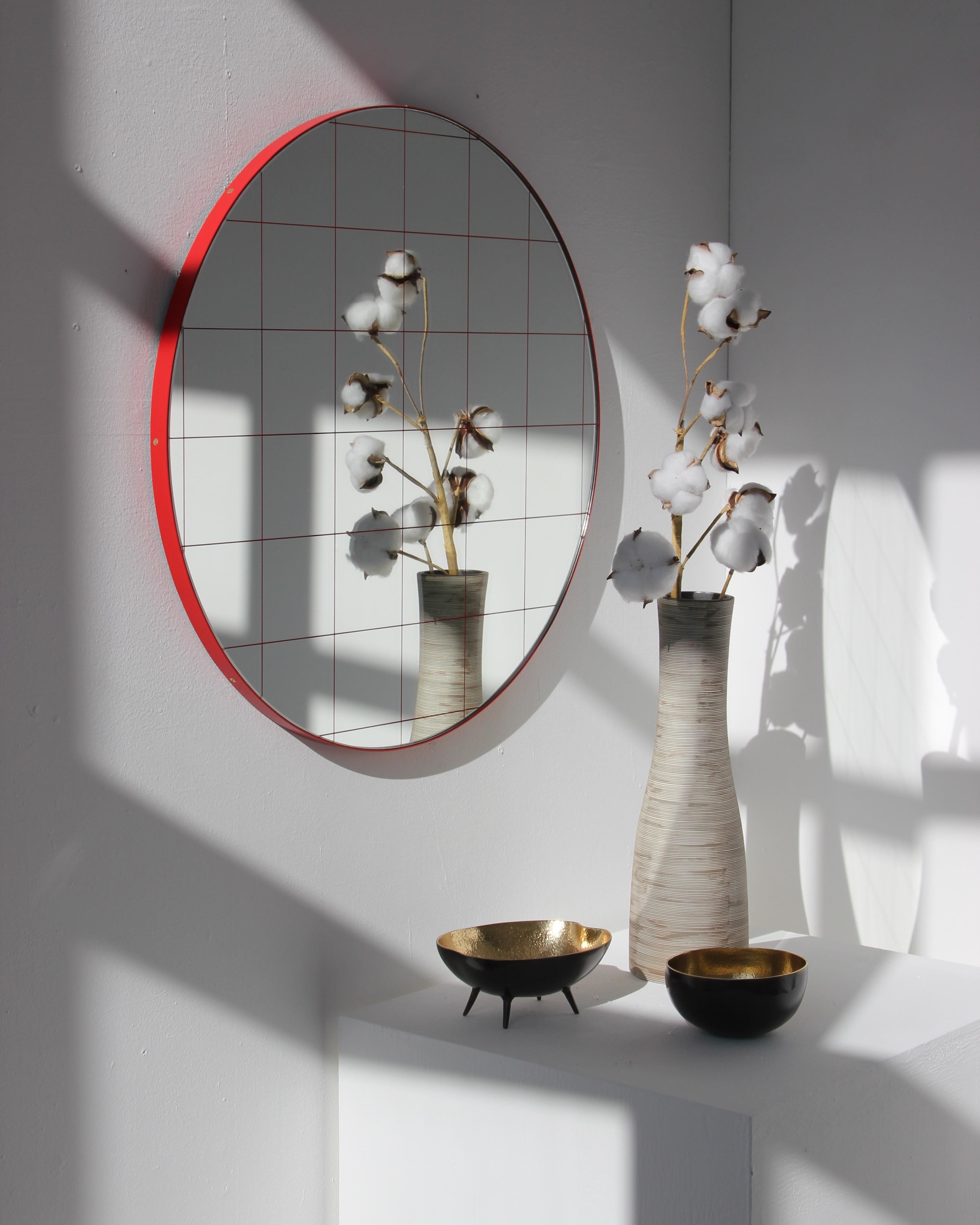 Modern decorative round Orbis mirror with a red grid and a powder coated red frame. Designed and handcrafted in London, UK.

Medium, large and extra-large mirrors (60, 80 and 100cm) are fitted with an ingenious French cleat (split batten) system so