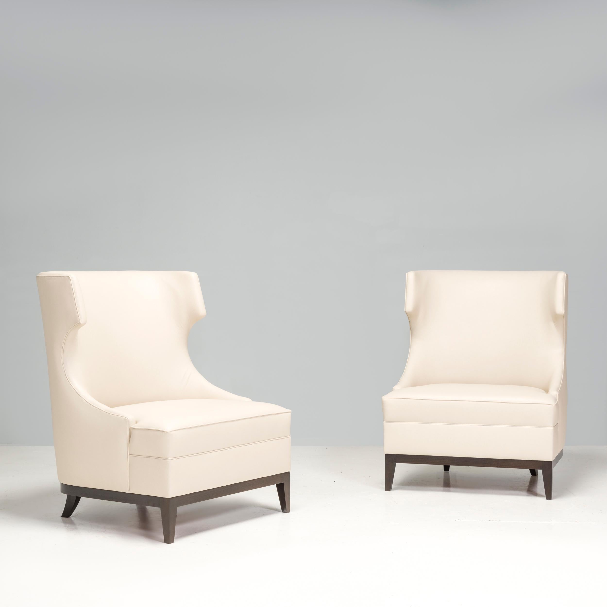 These cream leather high back armchairs have an impressive design that would elevate any living space or bedroom. Its neutral colour palette means it would harmonise well with a range of interior aesthetics.

Elegantly crafted with wingback