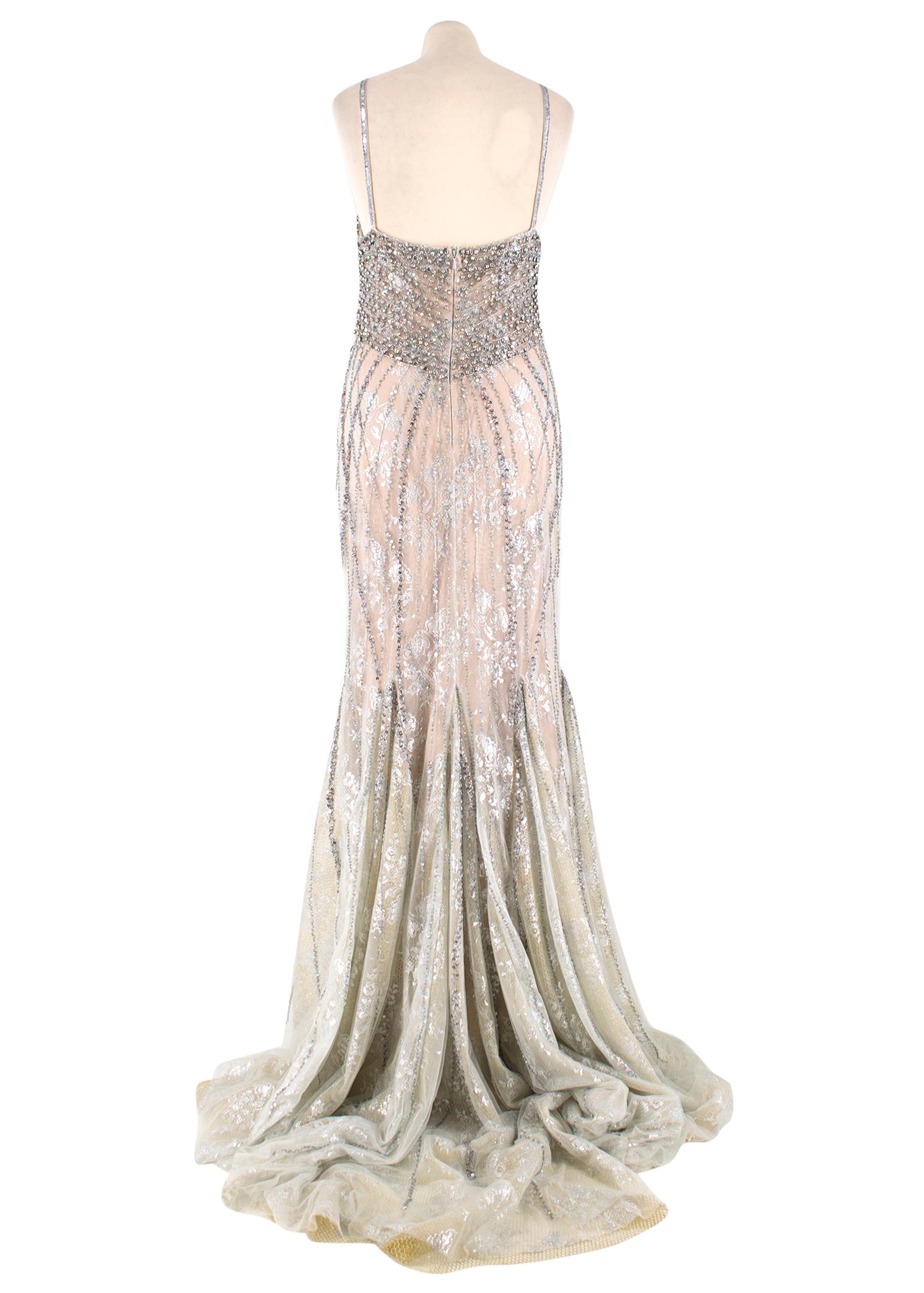 Bespoke Crystal Embellished Lace Gown

-Sheer lace dress with nude lining underneath 
-Padded Bust
-Fishtail skirt with train
-Crystal embellishment around bust which disperses down the dress
-V neck with crystal embellished spaghetti straps
-Back