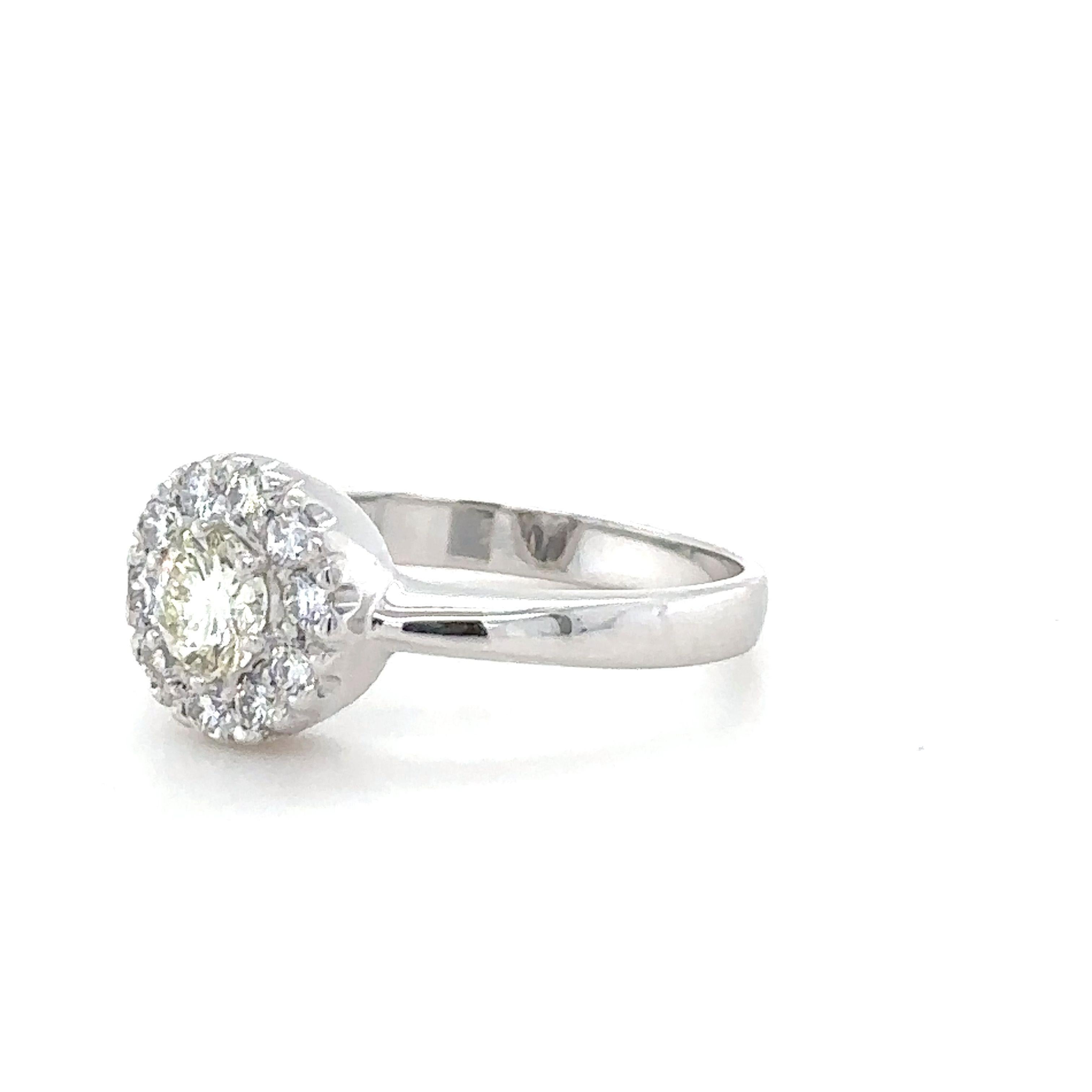 A Round Brilliant Cut Diamond Cluster Ring, made in 18ct White Gold, claw set with a border of 10 round brilliant cut diamonds on a 2.5mm reversed band. 
Diamonds 1 = 0.33ct, M Colour, VS Clarity  10 x diamonds = 0.30ct, G Colour, VS Clarity. Weight