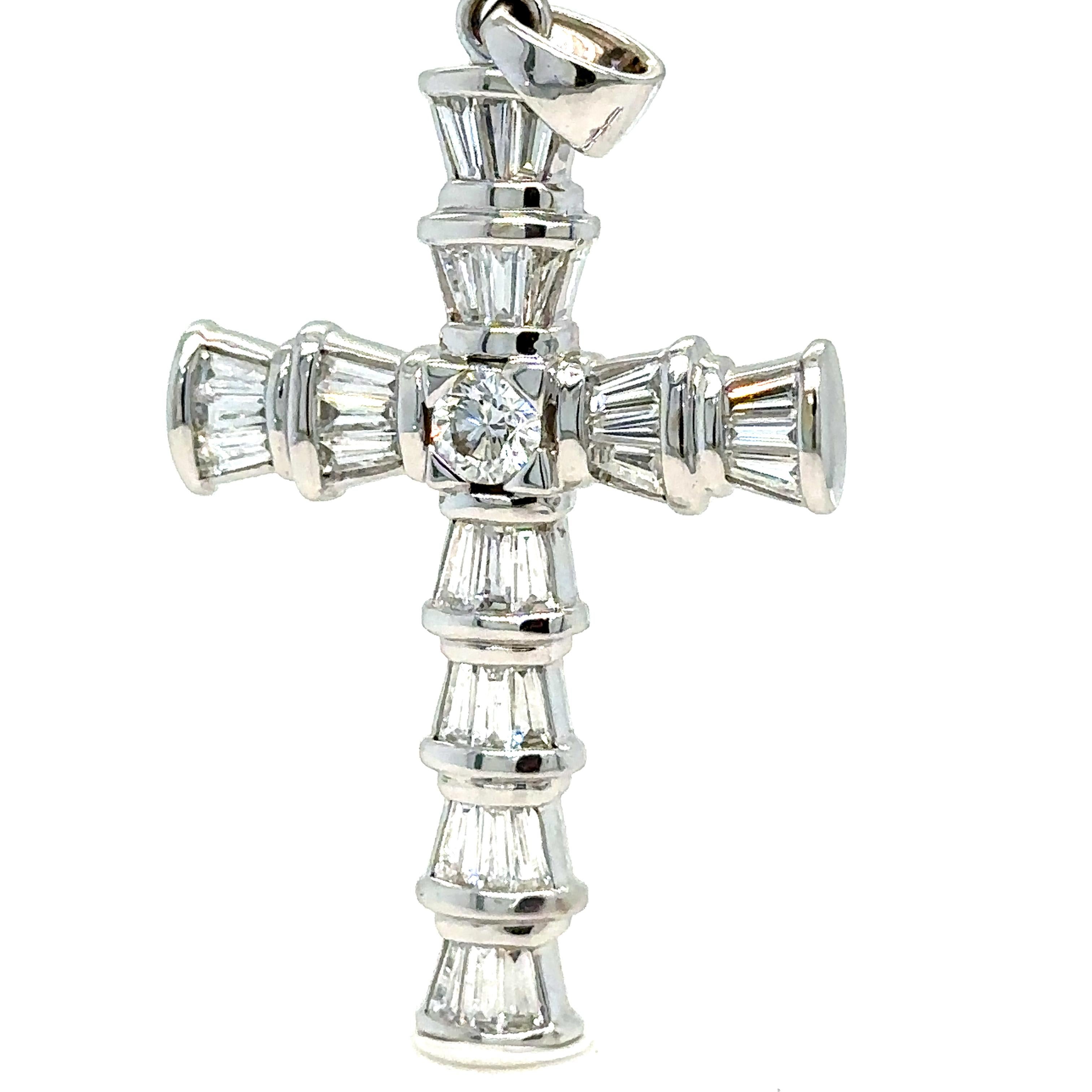 Unique features: 

One hallmarked 18ct White Gold Diamond set cross pendant containing 30 x channel set tapered baguette Diamonds & 1 x claw set Diamond.

Cross measures 4.00cm in length, with articulated tapered pendant bale attached.

Method of