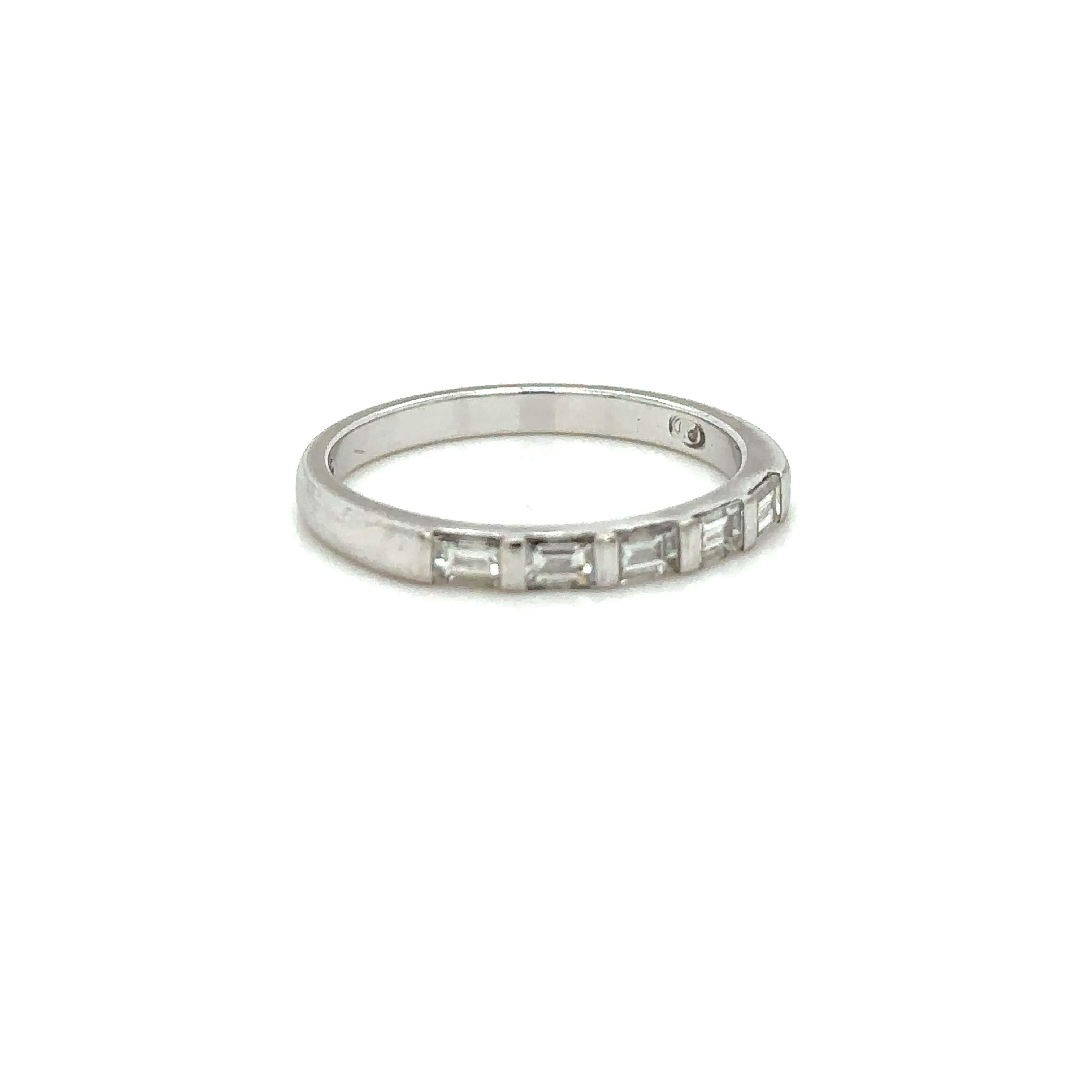 Unique features:
A women's, custom made, diamond Ring 

Diamond half eternity ring. Made of 18 kt White Gold, and ring size of N 1/2, and weighing 2.7gm. Stamped: 18ct. 

Total quantity of 5 baguette, step cut Diamonds, colour F and clarity VS. with