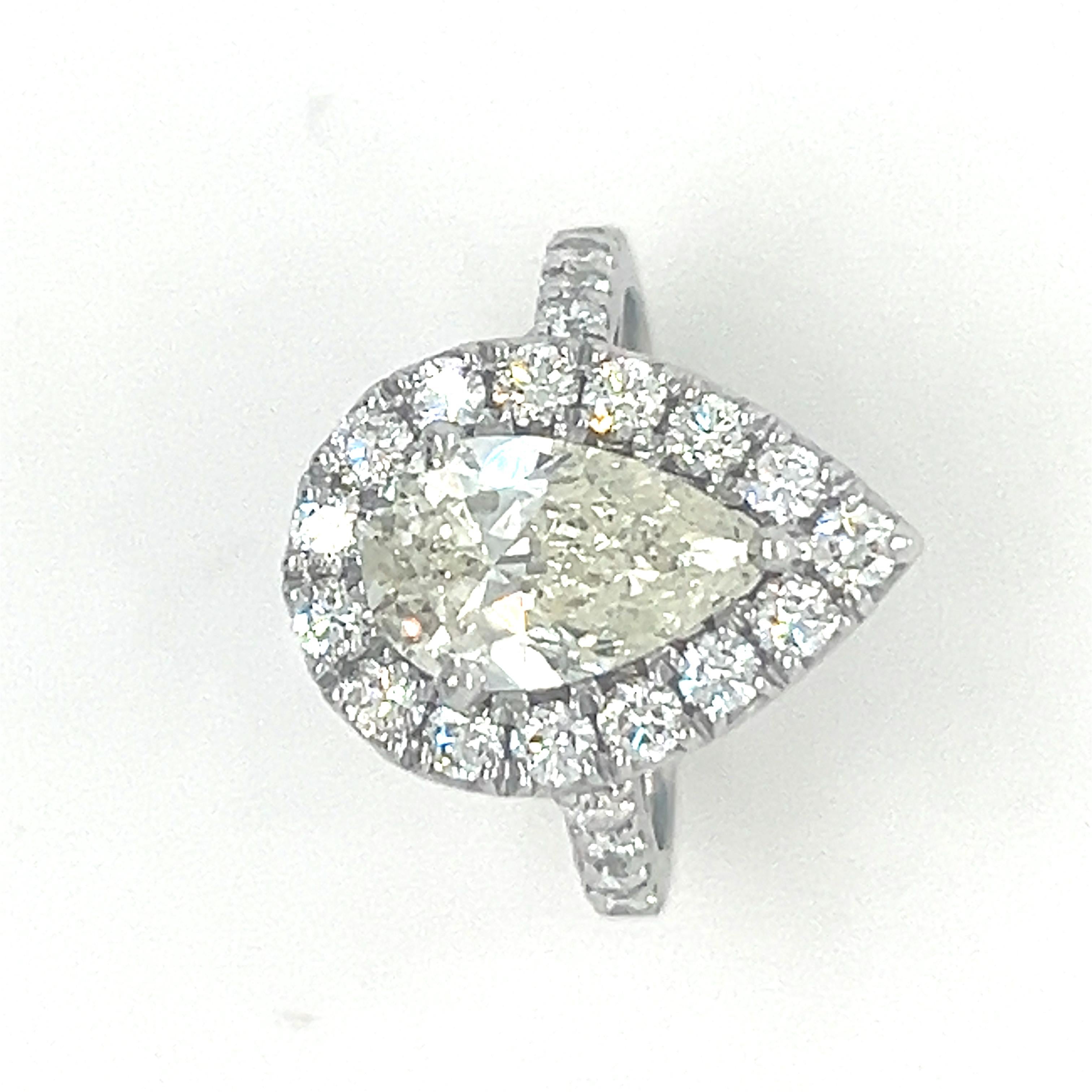 A Pear Shape Brilliant Cut Diamond Cluster Ring, three claw set 18ct white gold within a border of 15 round brilliant cut diamonds and with 8 round brilliant cut diamonds claw set down the shoulders on a 1.9mm band.

Diamonds 1 = 2.01ct (estimated),
