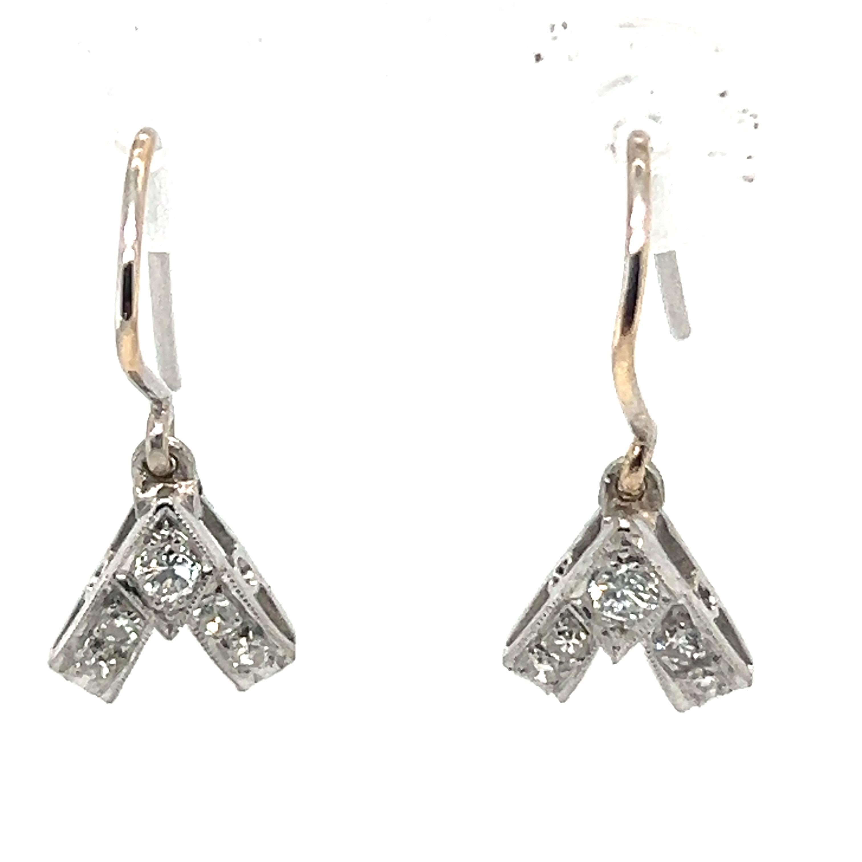 A Pair Of Vee-Shaped Drop Earrings, each set with a round brilliant cut diamond and 4 single cut diamonds bead set in 18ct white gold. 14ct gold wire hook fittings.

Diamonds 2 = 0.11ct (estimated), Graded in setting as Colour: G, Clarity: VS

8 =