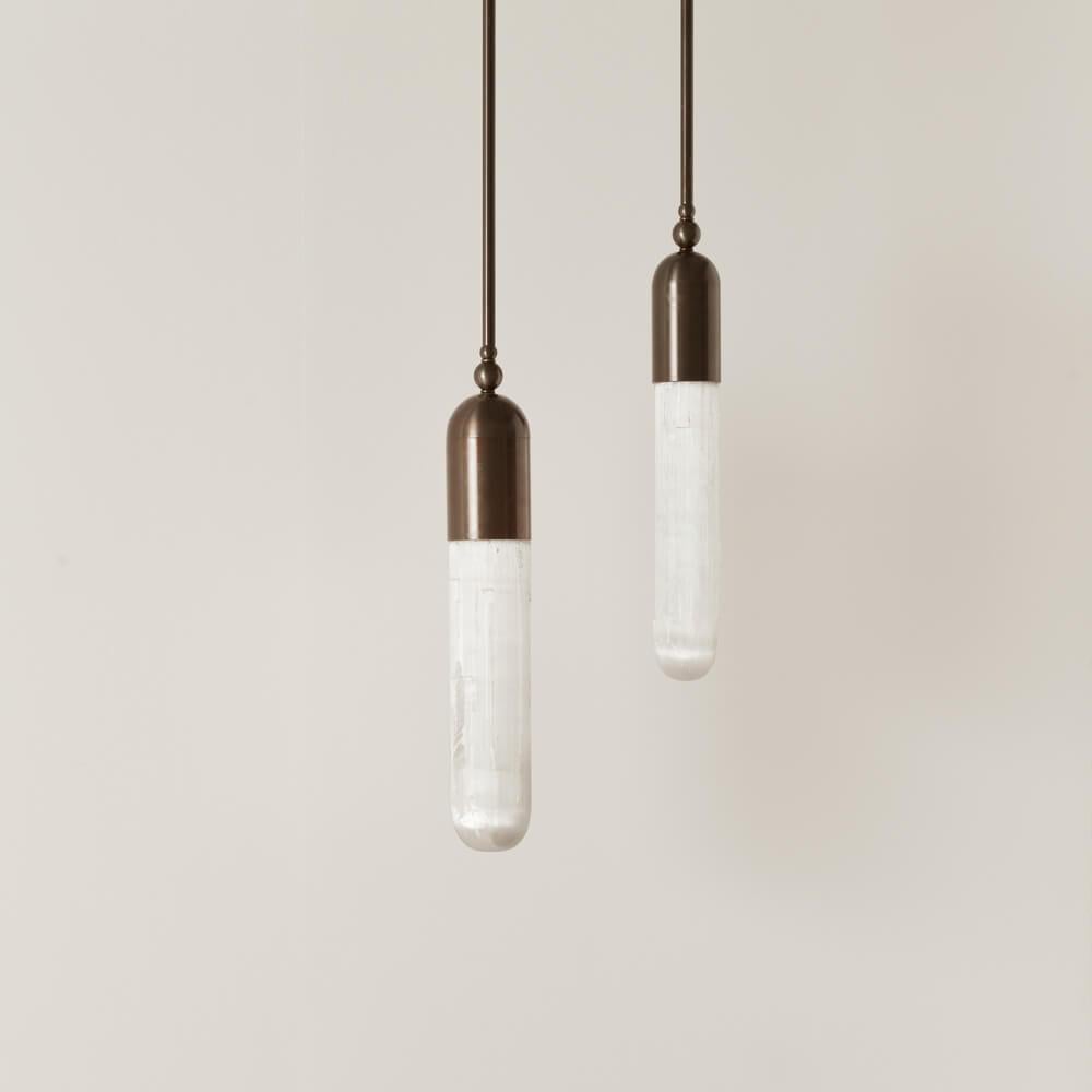The Selene range is the result of our project of combining light with a particular apotropaic stone - Selenite: a mineral chalk whose surface presents defined and irregular striations along the length of the crystal. The light that passes through