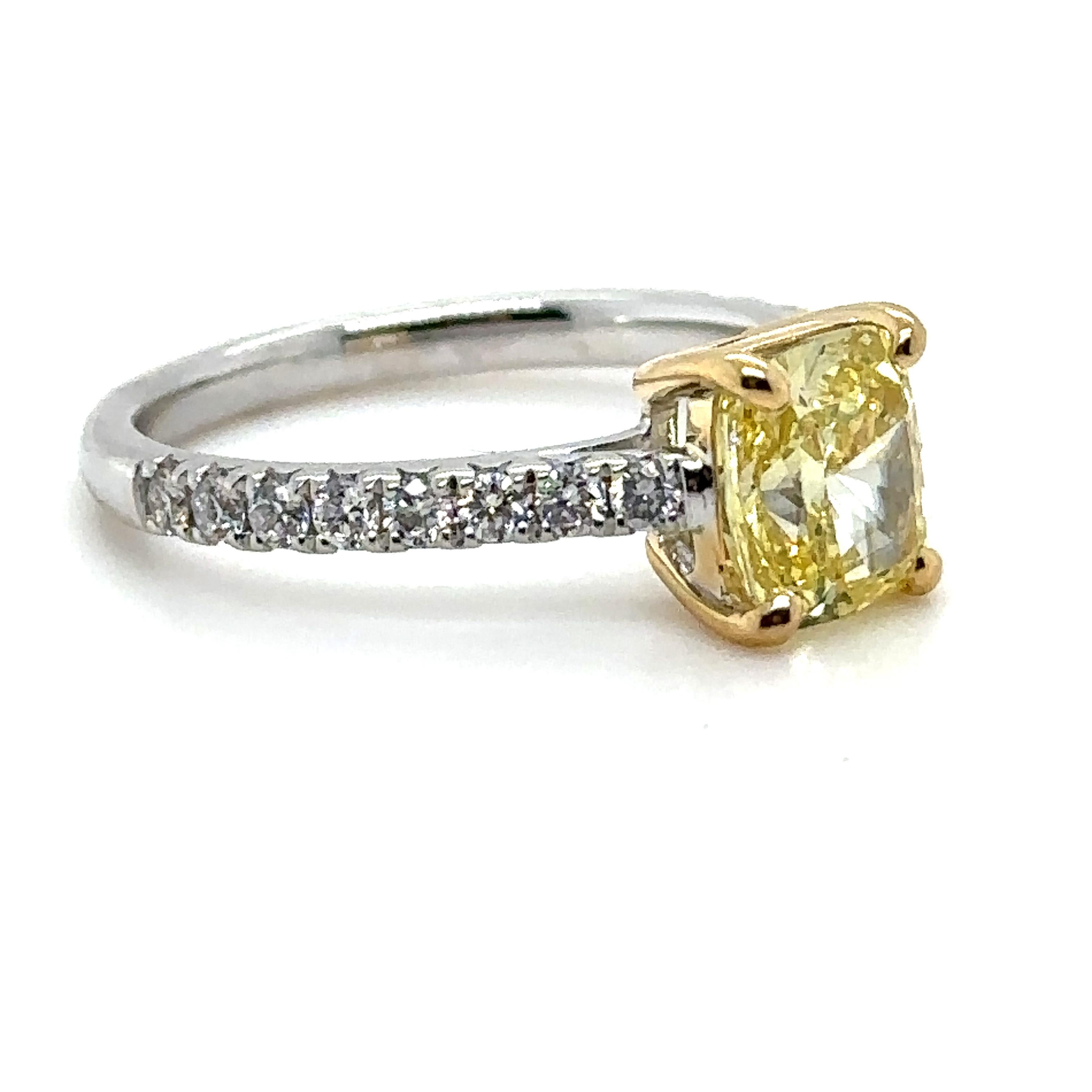 Unique features:

A Bespoke diamond engagement ring, made of 18ct Yellow and White Gold, and weighing 3.26gm. Stamped: 750.

Set with a Cushion, brilliant cut Diamond, colour intense fancy yellow, and clarity VS2. Weighing 1.63 ct. Certificate