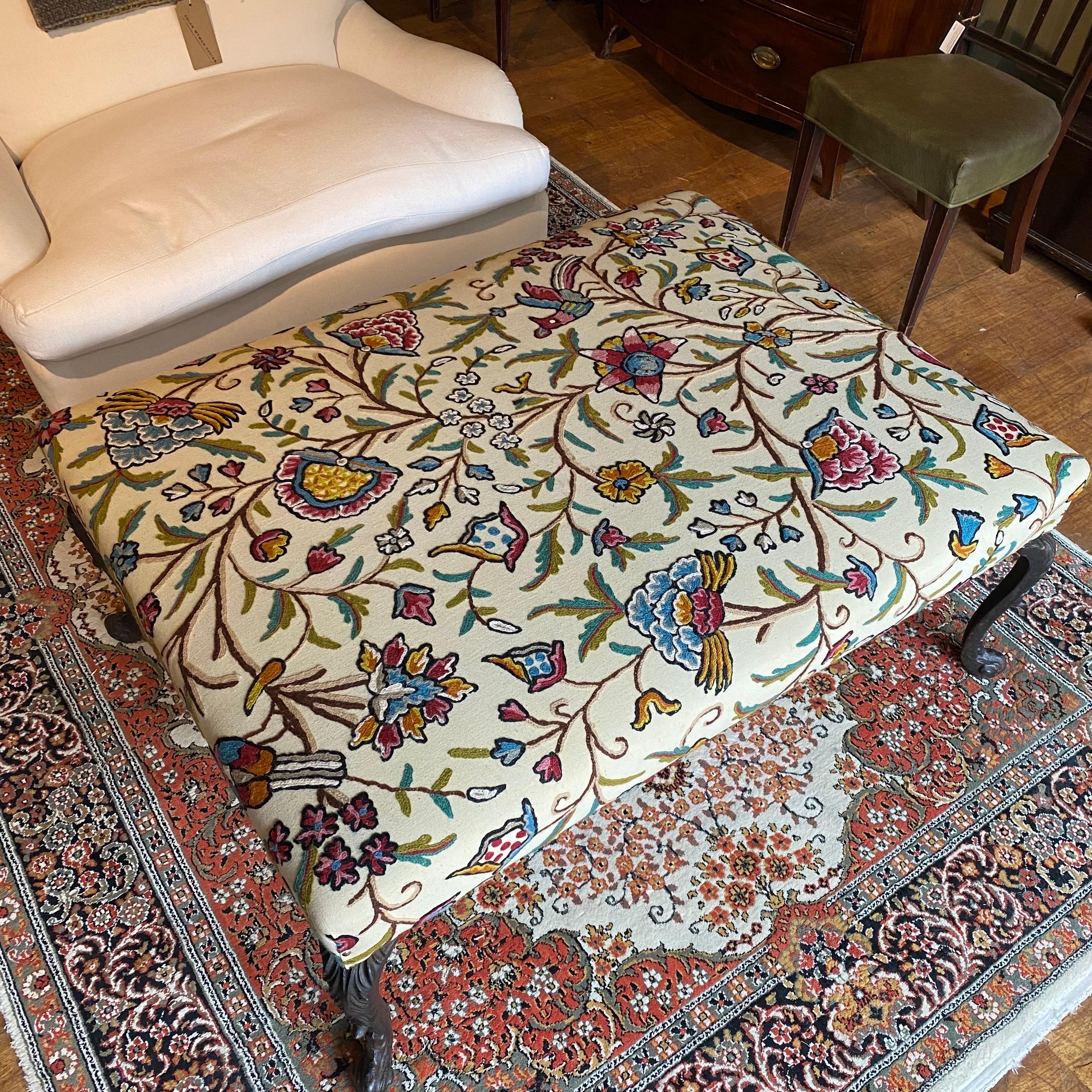 Beautiful bespoke made footstool / ottoman. 

A unique piece based around 4 cast iron legs, a modern handmade frame and then traditionally upholstered using a vintage crewel work. 

