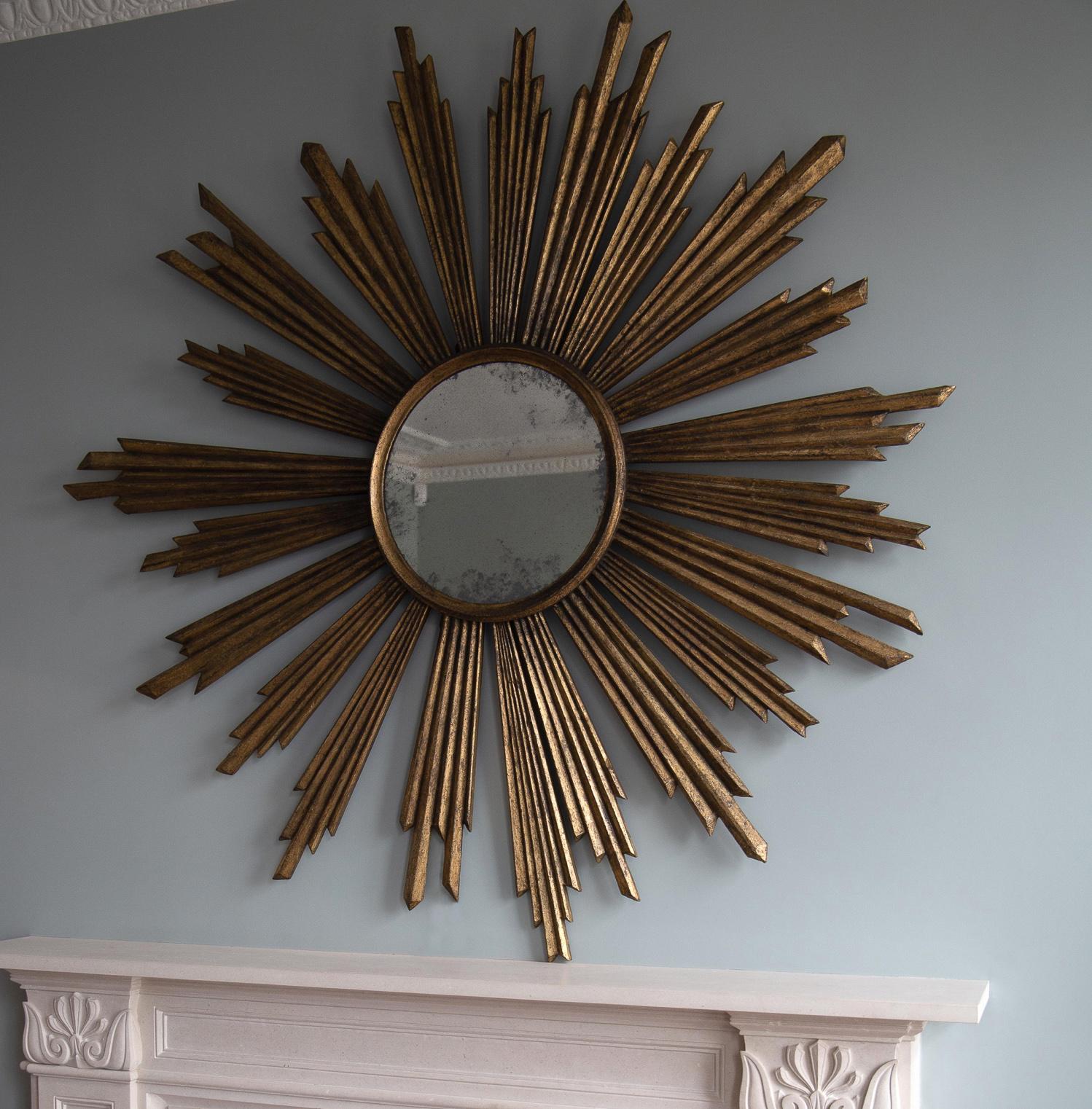 Grand proportions and exceptional patina.
Exceptional oil gilding designed to look aged on hand carved wooden frame with antiqued centre mirror glass.
A decorative statement piece with a real sense of scale made by finest British