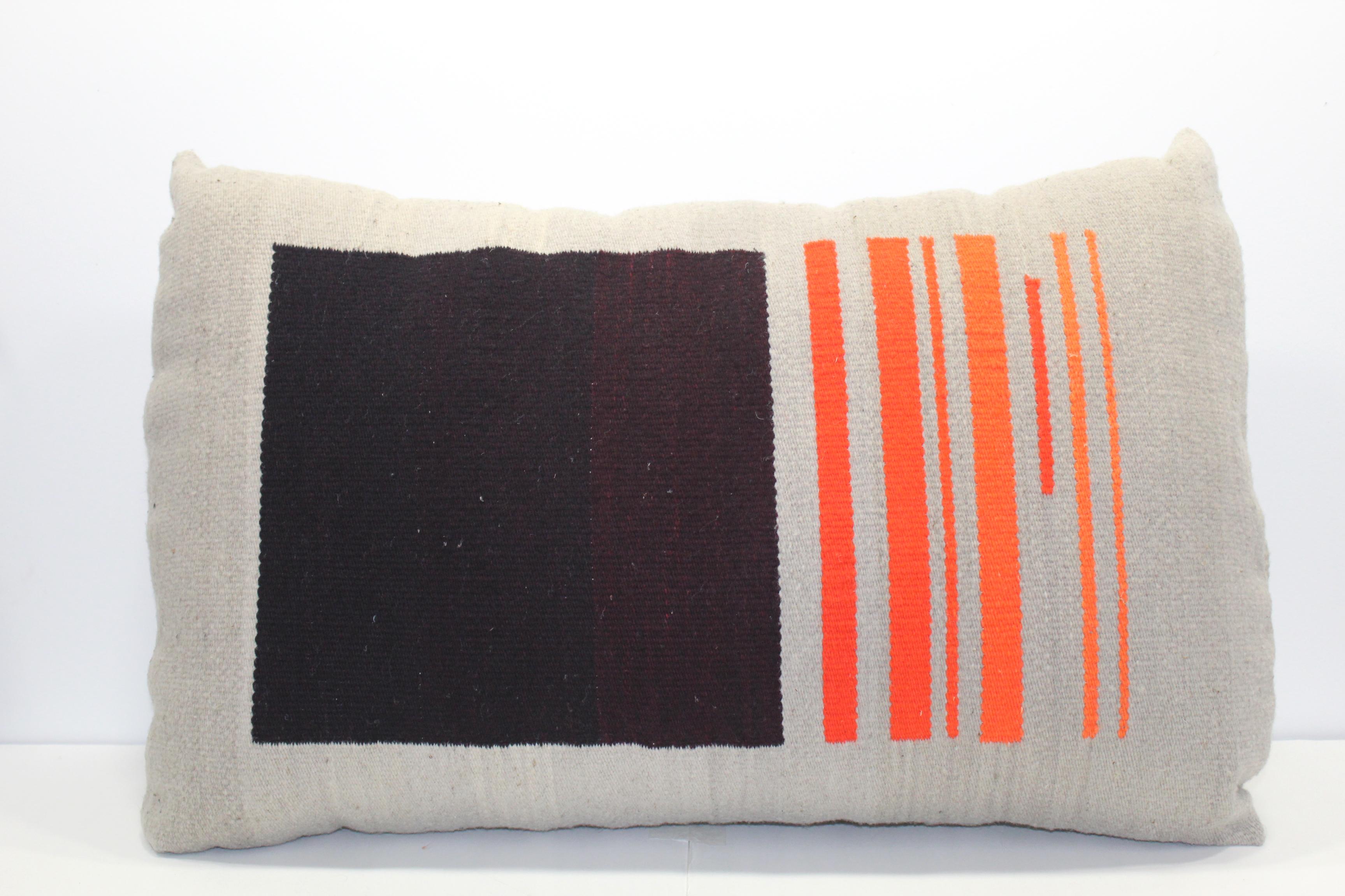 Contemporary handwoven wool throw pillow in red, orange and grey. 

Each color included in this pillow was hand-dyed with natural materials by the artist to achieve the subtle variety in tones. The shades of red and orange were created with