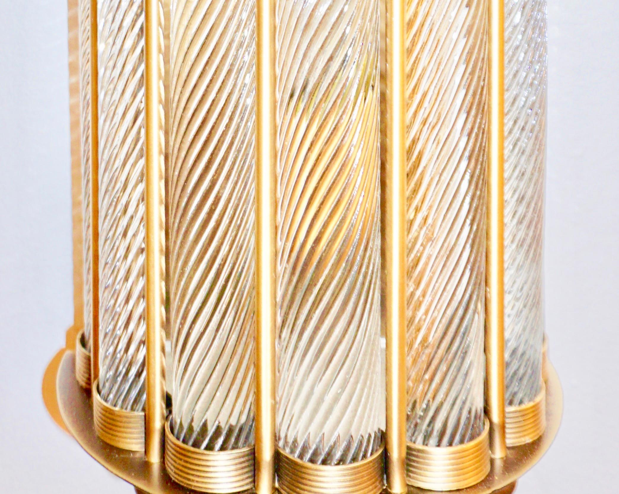 Contemporary customizable Italian Art Deco design pair of semi-circular wall lights, entirely handcrafted in brass. The nicely scalloped airy brass structure supports 7 crystal clear Murano glass rods worked with the sophisticated technique Torchon,