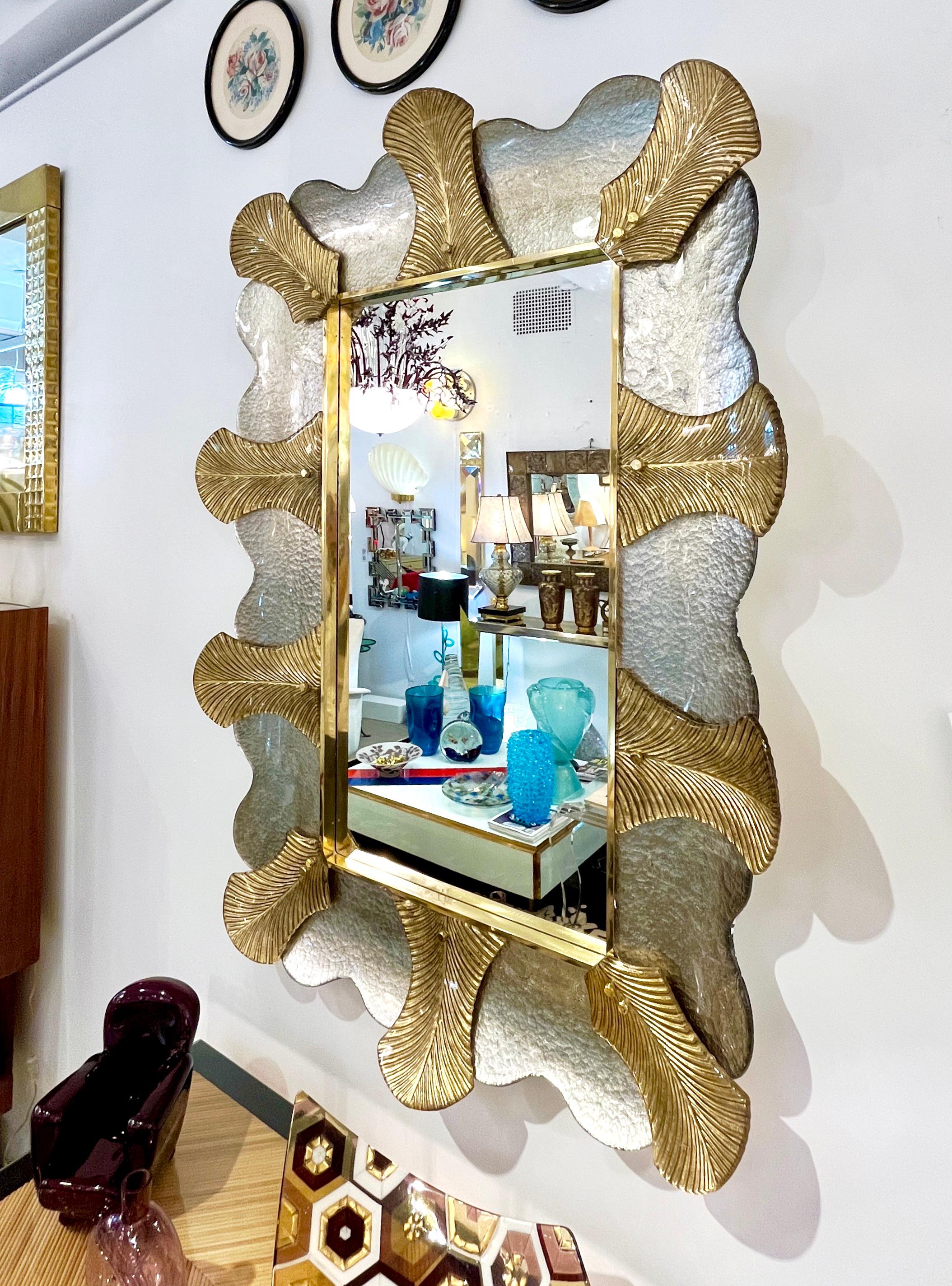 A pair is available now - Venetian contemporary Couture design rectangular wall mirror, custom made in Italy, framed with a thick border in Art Deco Design, composed of high quality blown Murano art glass textured leaves worked with 24-karat gold