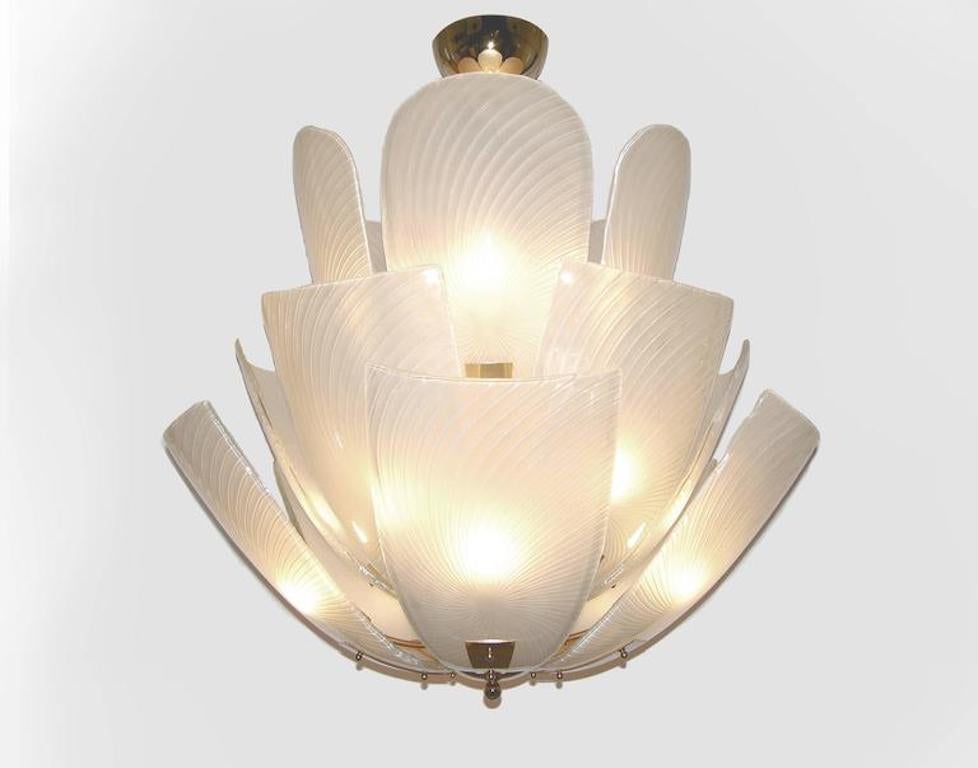 A contemporary creation of the highest quality, this lighting fixture, entirely hand made in Italy, is composed of white Murano glass leaves, that are arranged in a lotus flower shape, each individually blown and handcrafted, preciously decorated in
