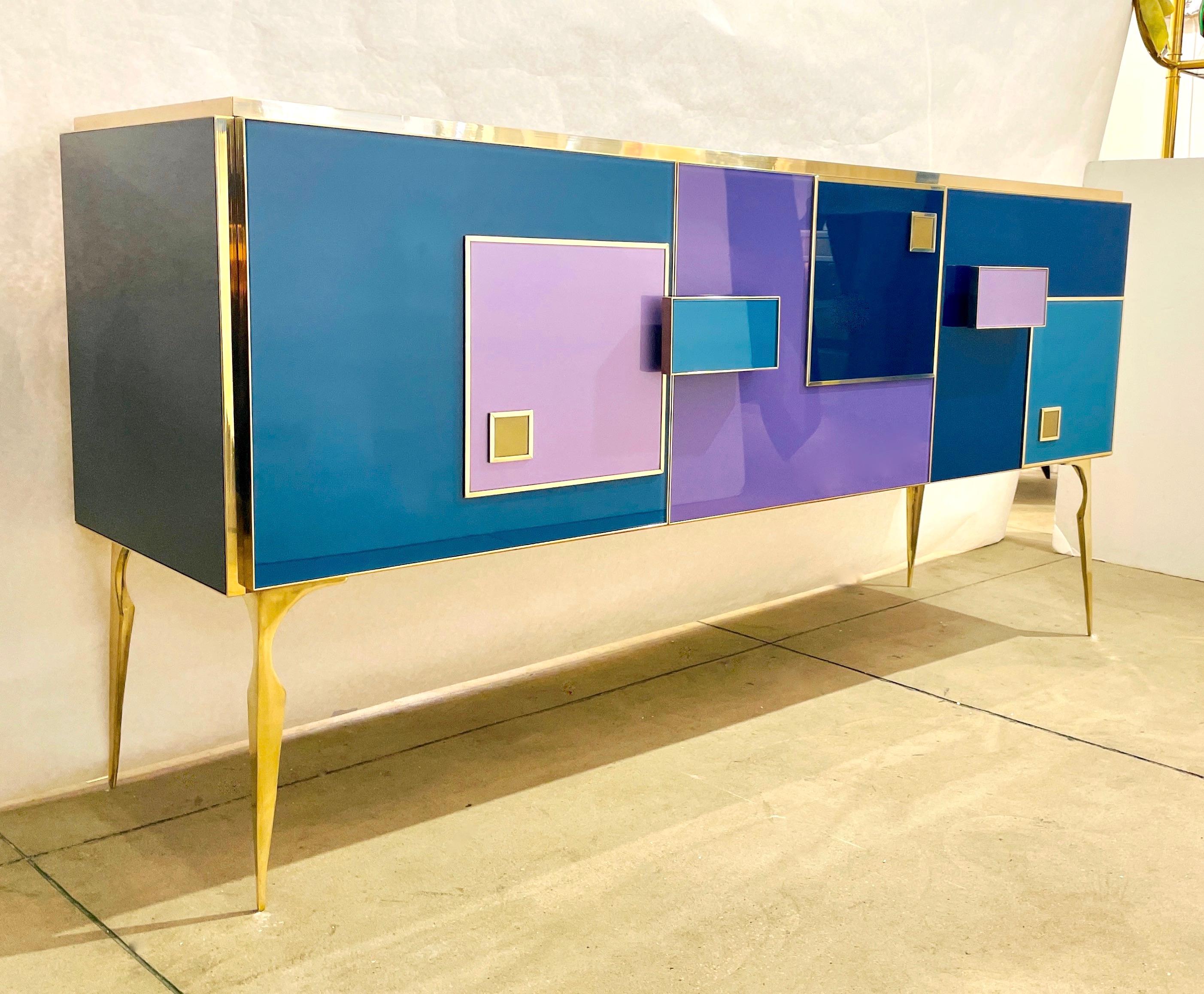 A creative 2-compartment, 3-door modern credenza, entirely handmade in Italy with high-quality details of execution in an attractive geometric decor with raised pattern and handles, finished wooden back. An elegant, artistic, functional buffet or