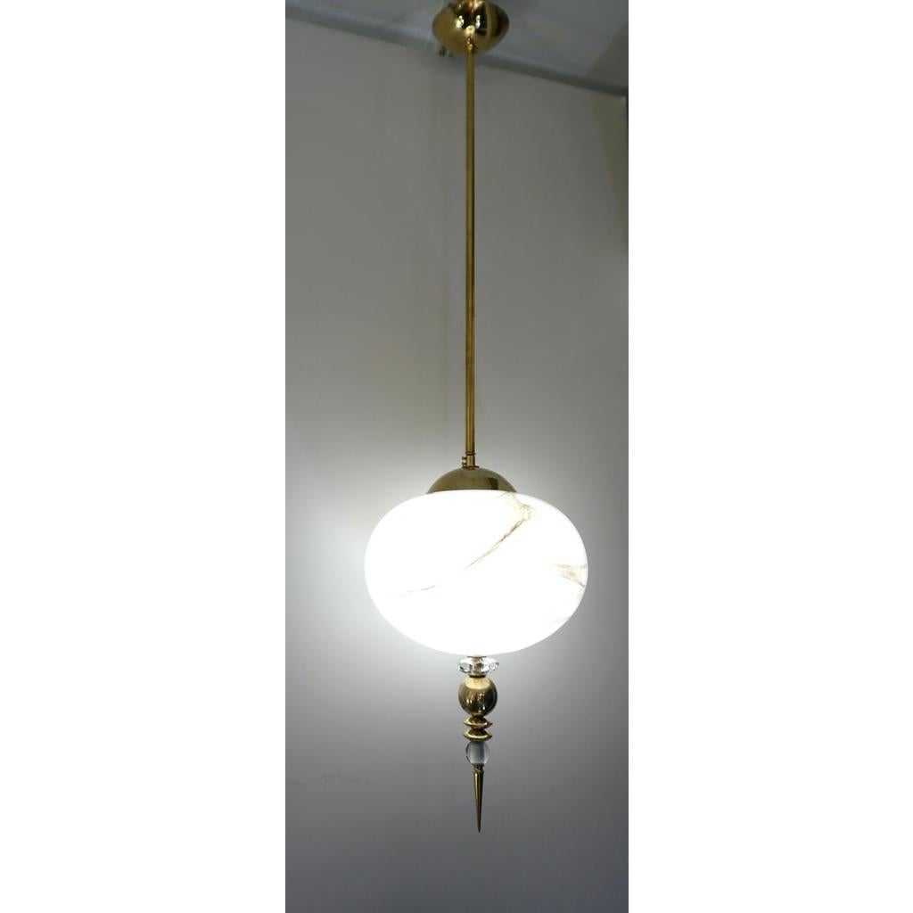 A contemporary custom egg shape pendant chandelier of a modern geometric series, entirely handcrafted in Italy, the organic oval globe in an innovative blown Murano glass to resemble alabaster with the benefit to be lighter and to remain over time