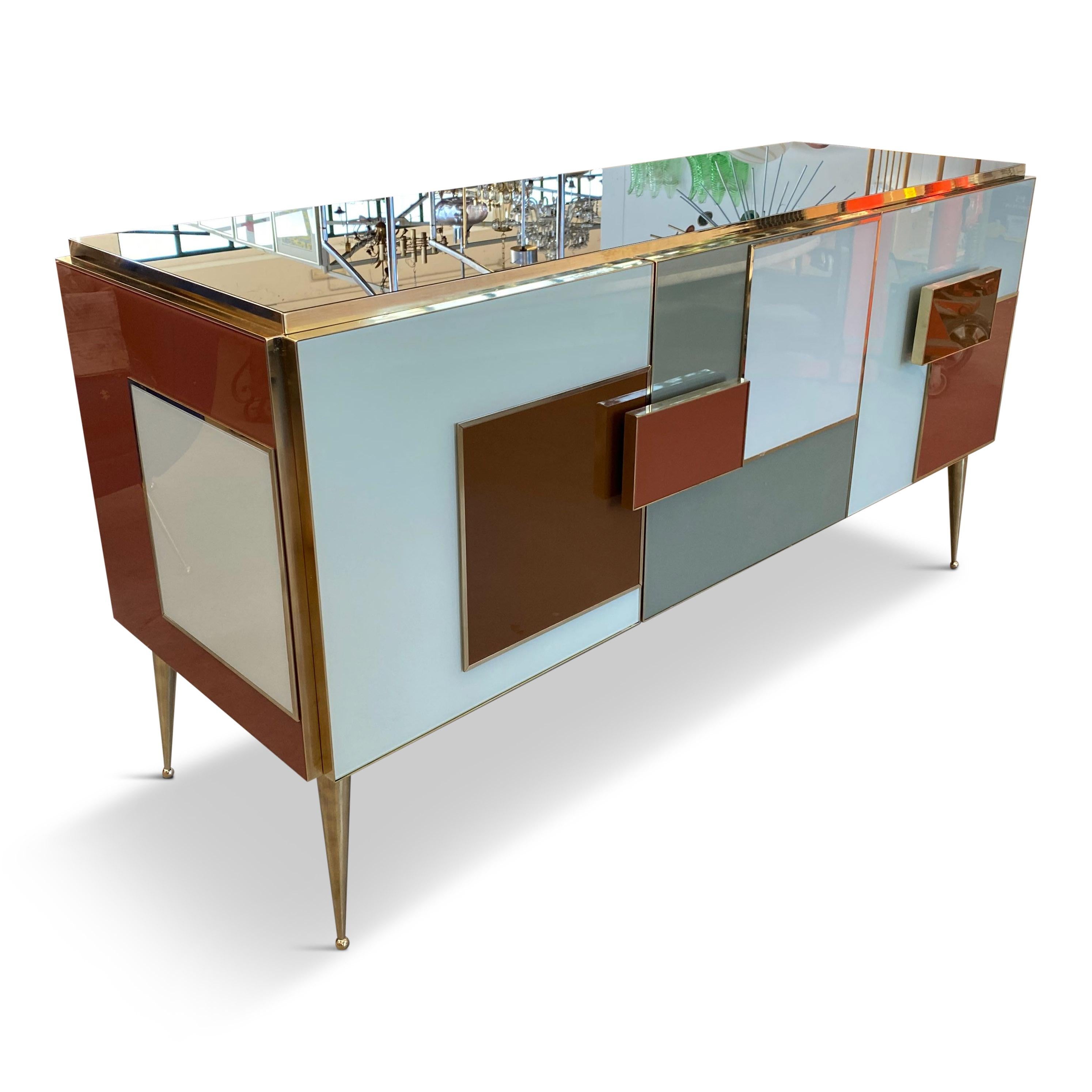 Bespoke sideboard

Colored glass panels

Brass inlay

Brass legs

Contemporary, Italy.