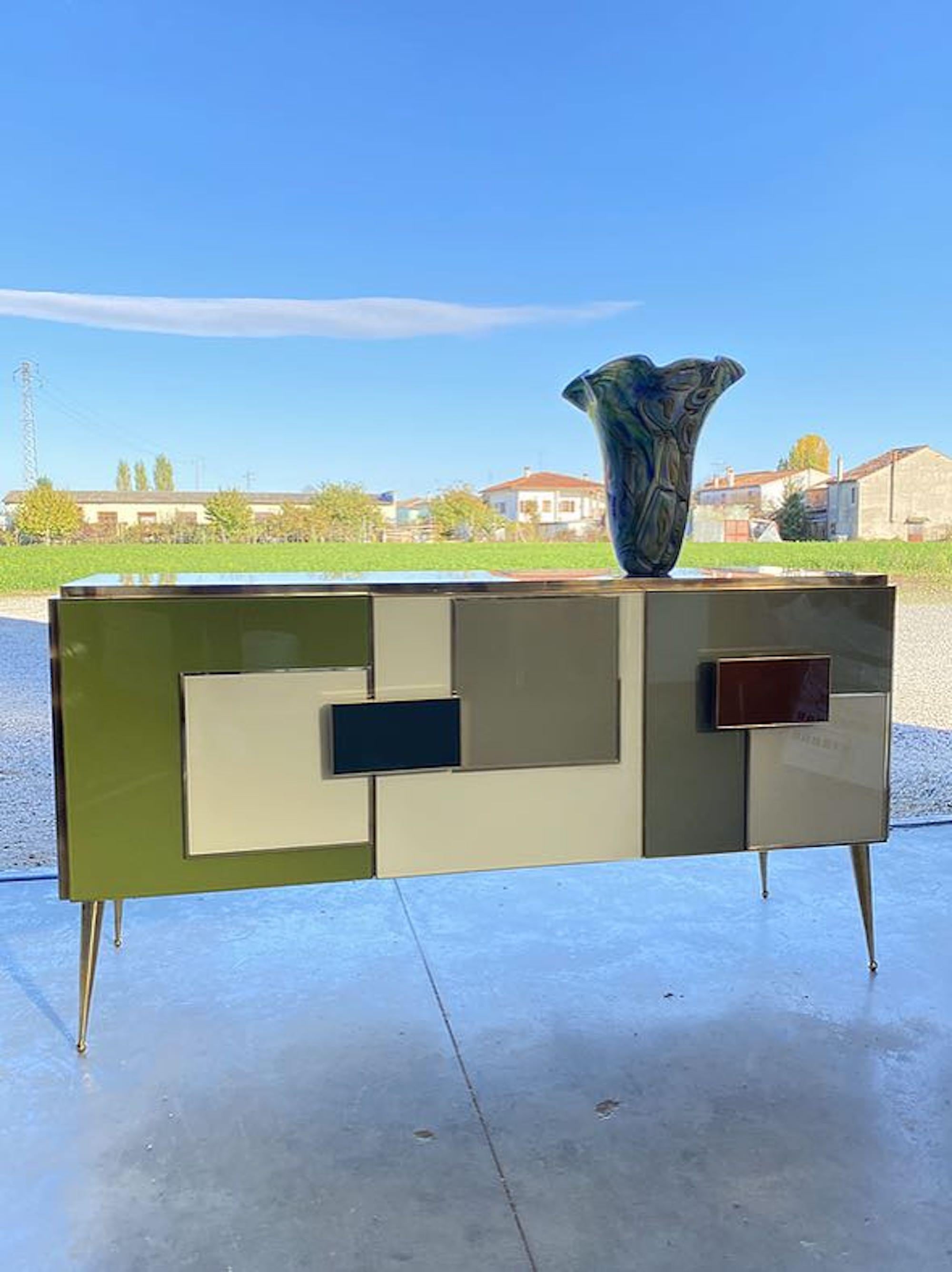 Bespoke sideboard

Colored glass panels

Brass inlay

Brass legs

Contemporary, Italy.