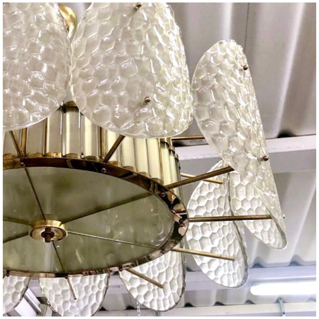 A contemporary custom organic modern flushmount, entirely handcrafted in Italy, with a handmade brass double frame with Art Deco flair and Hollywood glam. The exterior is formed by nature-inspired oval convex elements resembling sea turtle backs in