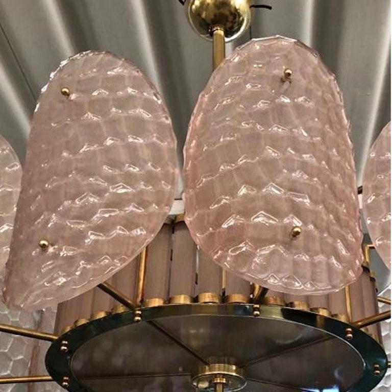 A contemporary custom organic modern chandelier, entirely handcrafted in Italy, with a handmade brass double frame with Art Deco flair.
The exterior is formed by nature-inspired oval convex elements resembling sea turtle backs in blown textured