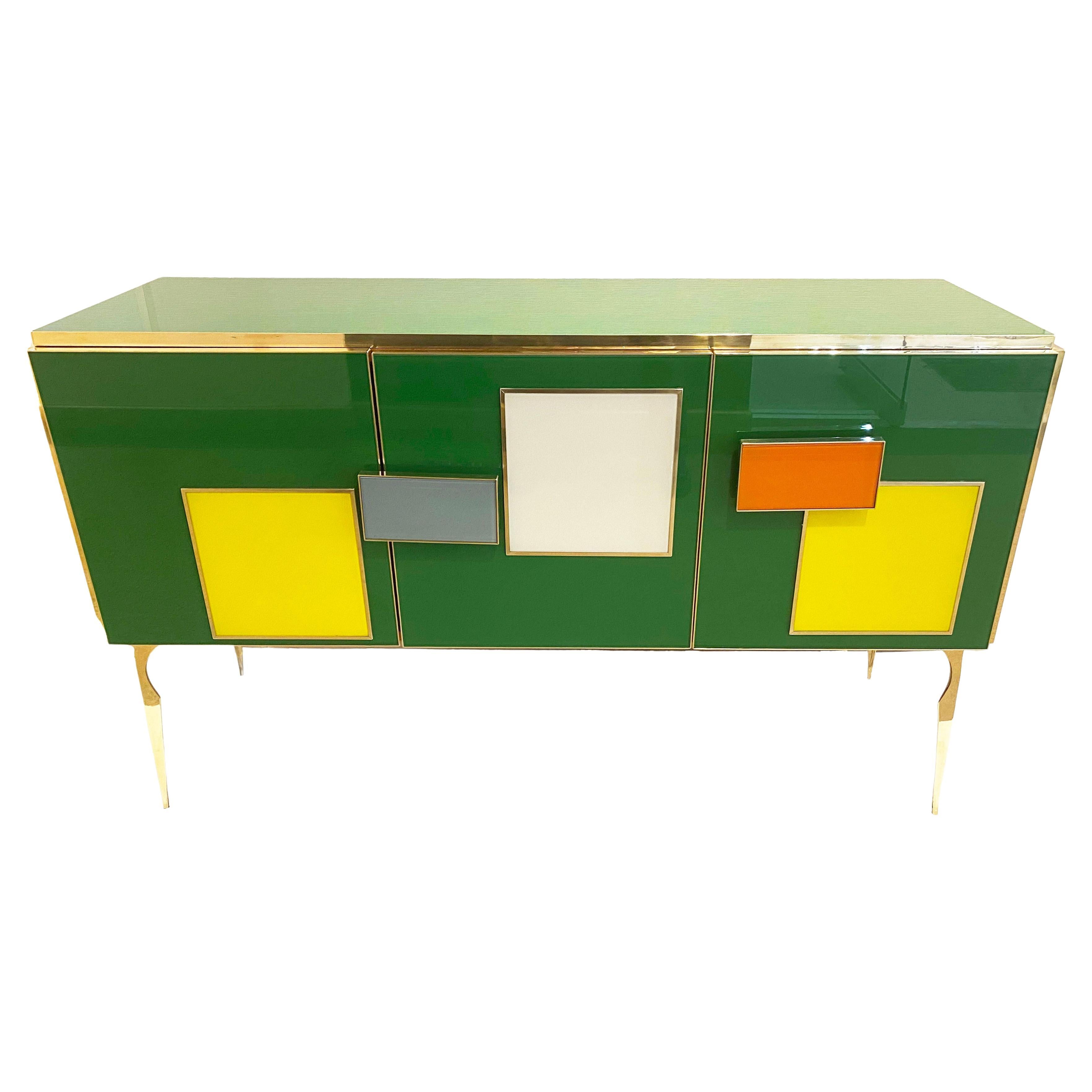 Bespoke customizable 3-door modern cabinet sideboard, entirely handcrafted in Italy with Memphis inspiration for the attractive colorful geometric decor with raised pattern and handles. The surround is decorated with art glass in a striking