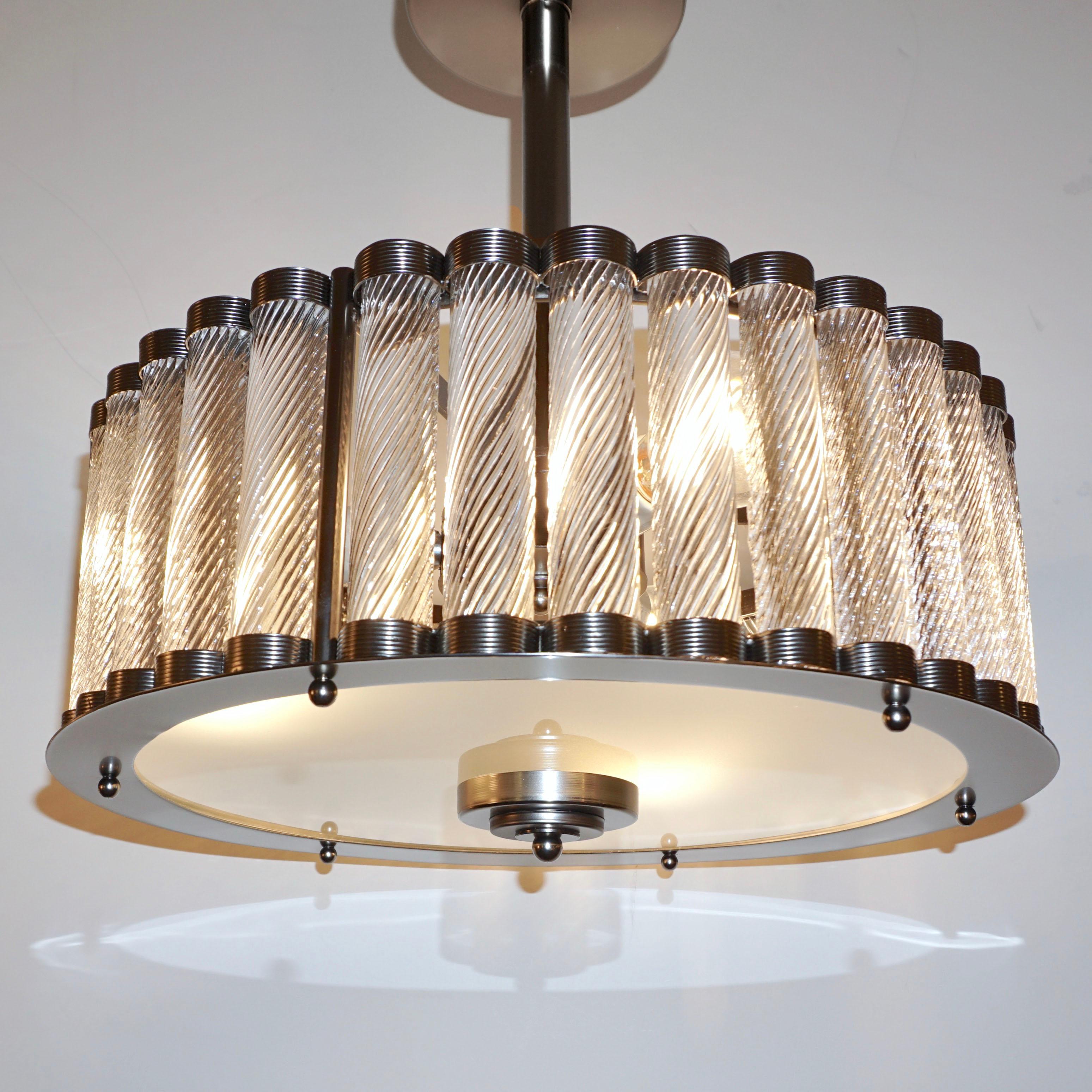 Contemporary Italian Art Deco Design customizable round chandelier/pendant of drum shape, entirely handcrafted, with a dark steel pewter metal finish. The nicely scalloped airy structure supports crystal clear Murano glass rods, each individually