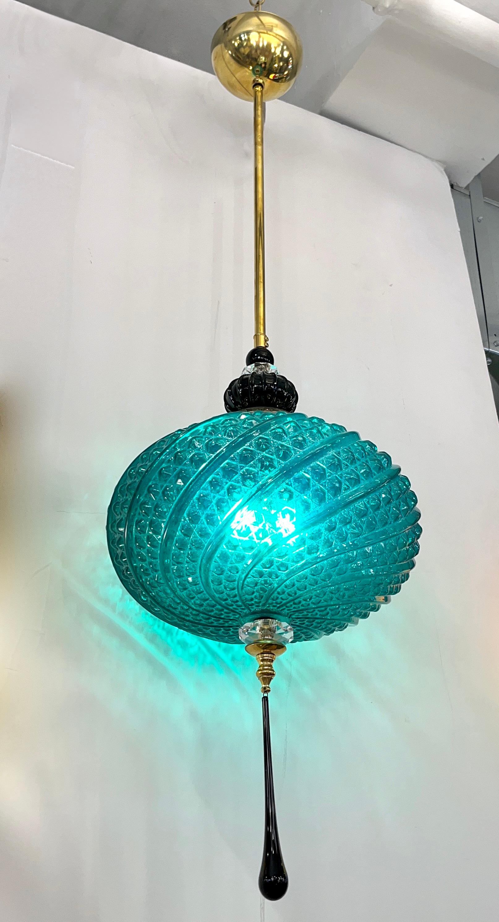Contemporary orientalist style custom lantern pendant chandelier, of a modern Venetian geometric series with 4 shapes as per images, entirely custom made in Italy, here with brass hardware, the organic horizontal oval shape globe in an innovative