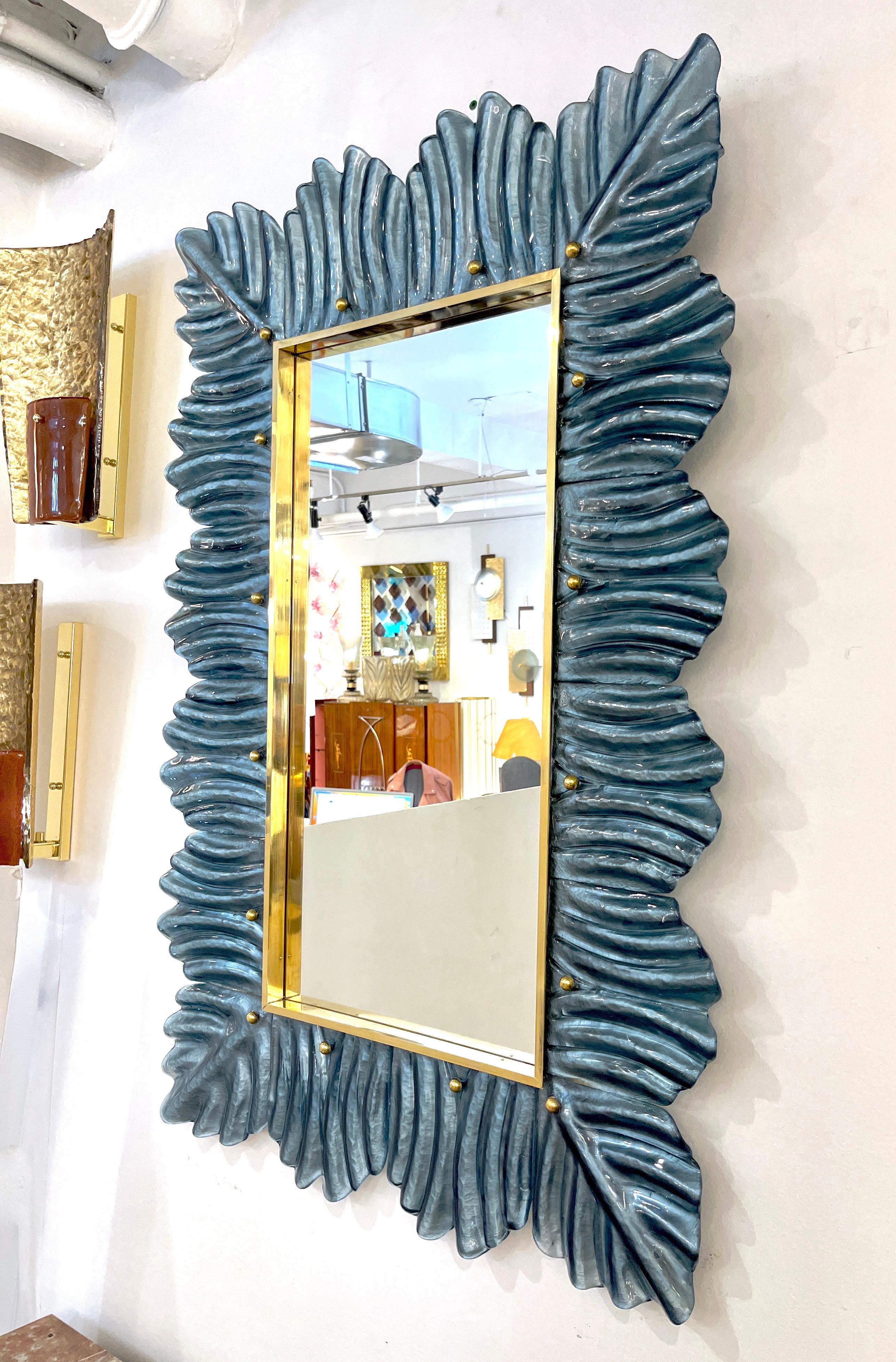 Venetian contemporary Couture design rectangular wall mirror, custom made in Italy, framed with a thick border in blown Murano art glass, with an organic reeded leaf pattern in Art Deco Design. High quality of execution and details: the blue color