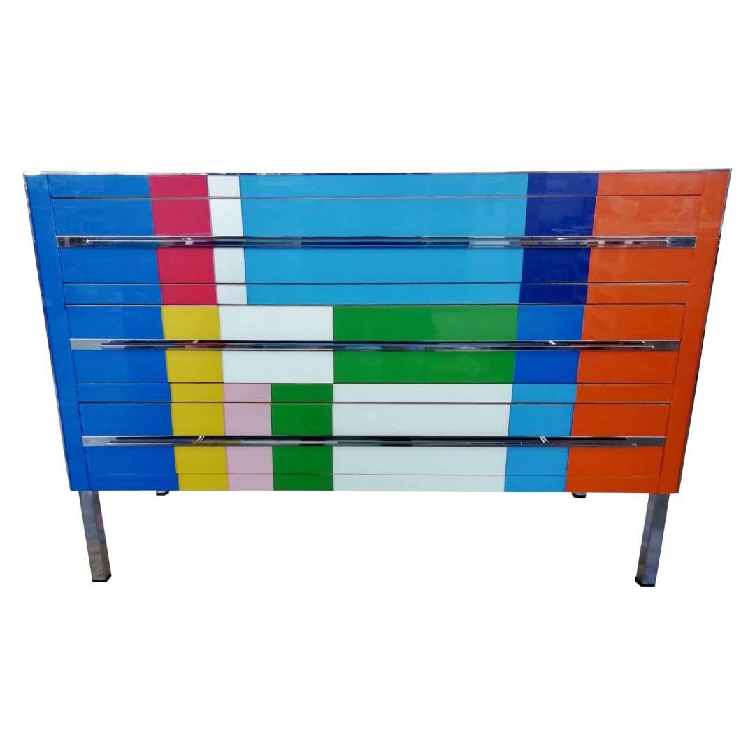 Contemporary modern graphic Pop Art design three-drawer dresser/sideboard, entirely handcrafted in Italy, with a Piet Mondrian inspired abstract decor, the surrounds edged in polished nickel trim are in colored glass: navy blue, aquamarine, moss