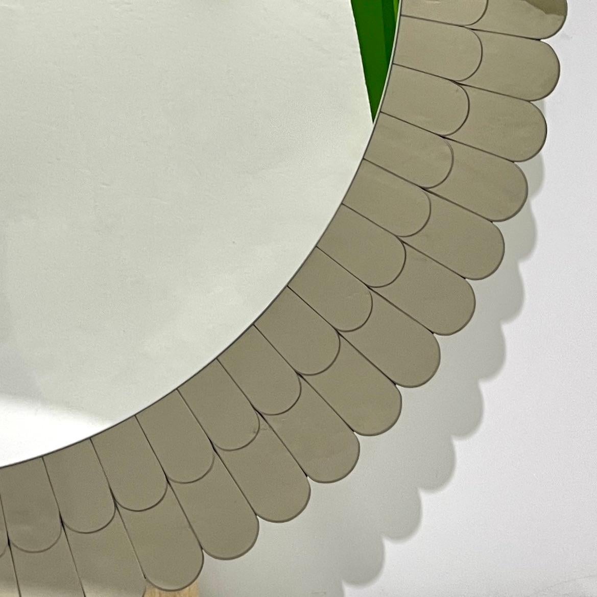 Elegant sculpture mirror of large round shape, entirely handcrafted in Italy, highest quality of construction and attention to details: the scalloped double frame in smoked bronze mirrored Murano glass is composed of individual petals arranged