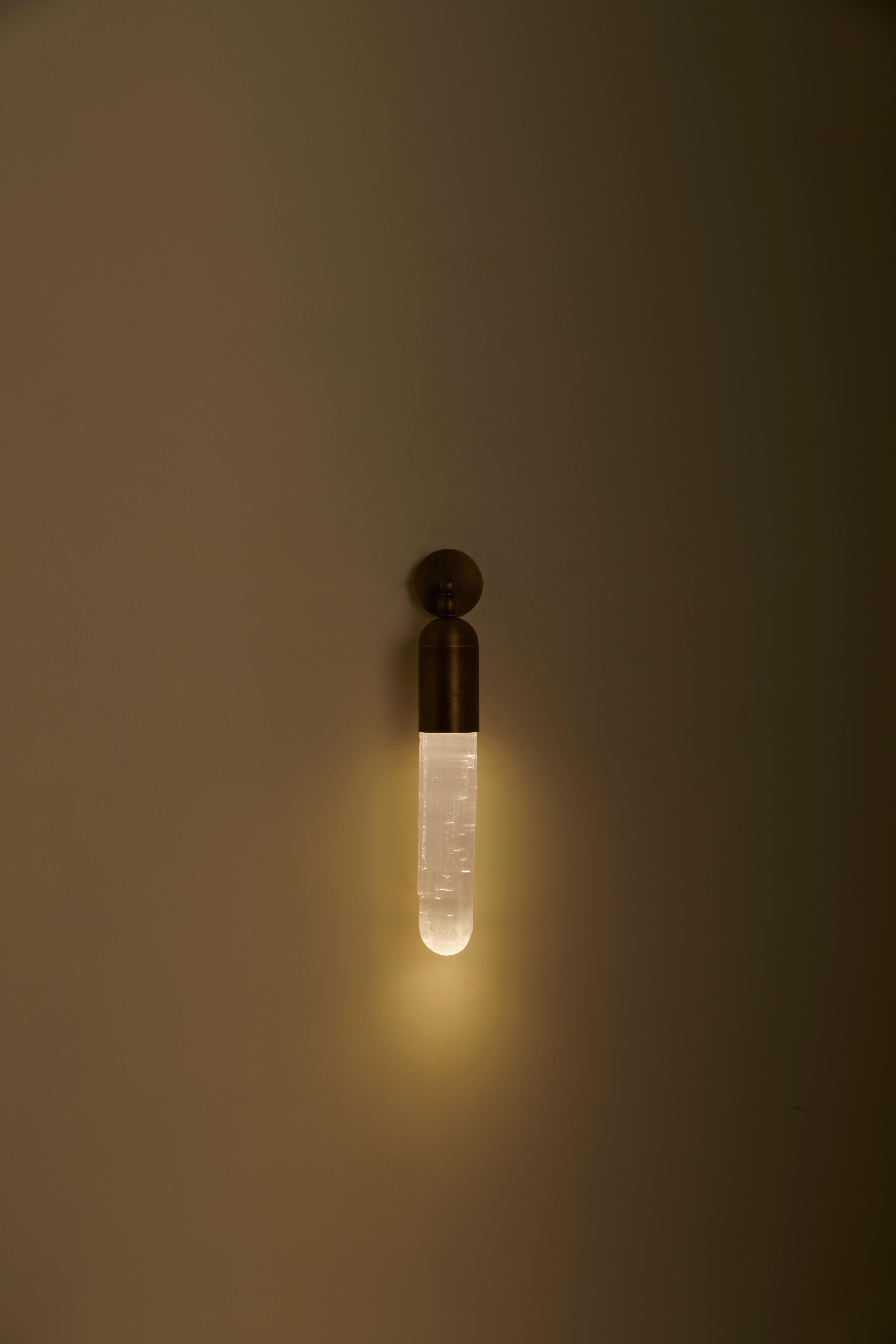 The Selene range is the result of our project of combining light with a particular apotropaic stone - Selenite: a mineral chalk whose surface presents defined and irregular striations along the length of the crystal. The light that passes through