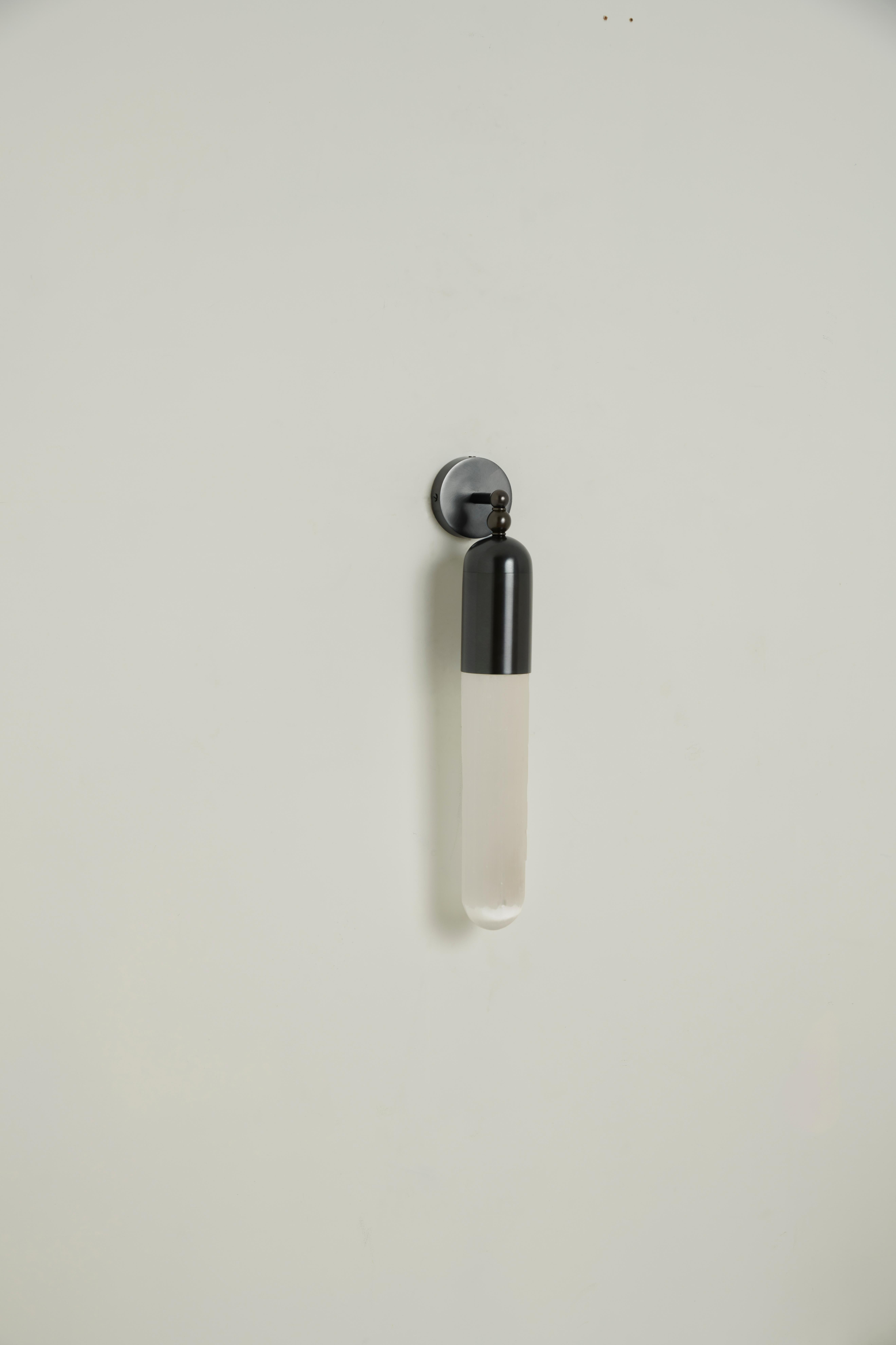 The Selene range is the result of our project of combining light with a particular apotropaic stone - Selenite: a mineral chalk whose surface presents defined and irregular striations along the length of the crystal. The light that passes through