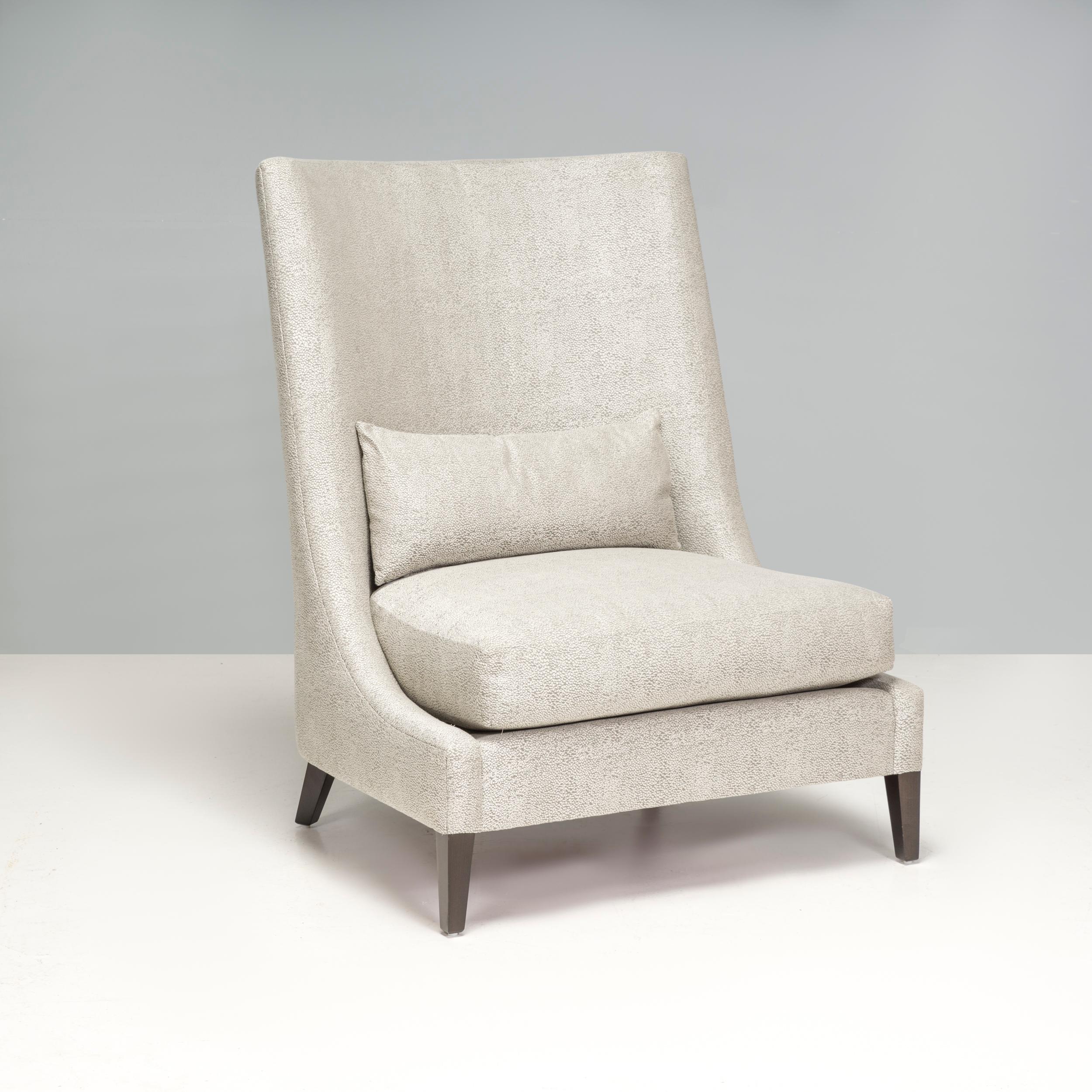The light grey high back armchair has an impressive design that would elevate any living space or bedroom. 

The neutral colour palette mean it would harmonise well with a range of interior aesthetics. The back if the chair swoops into a low seat,